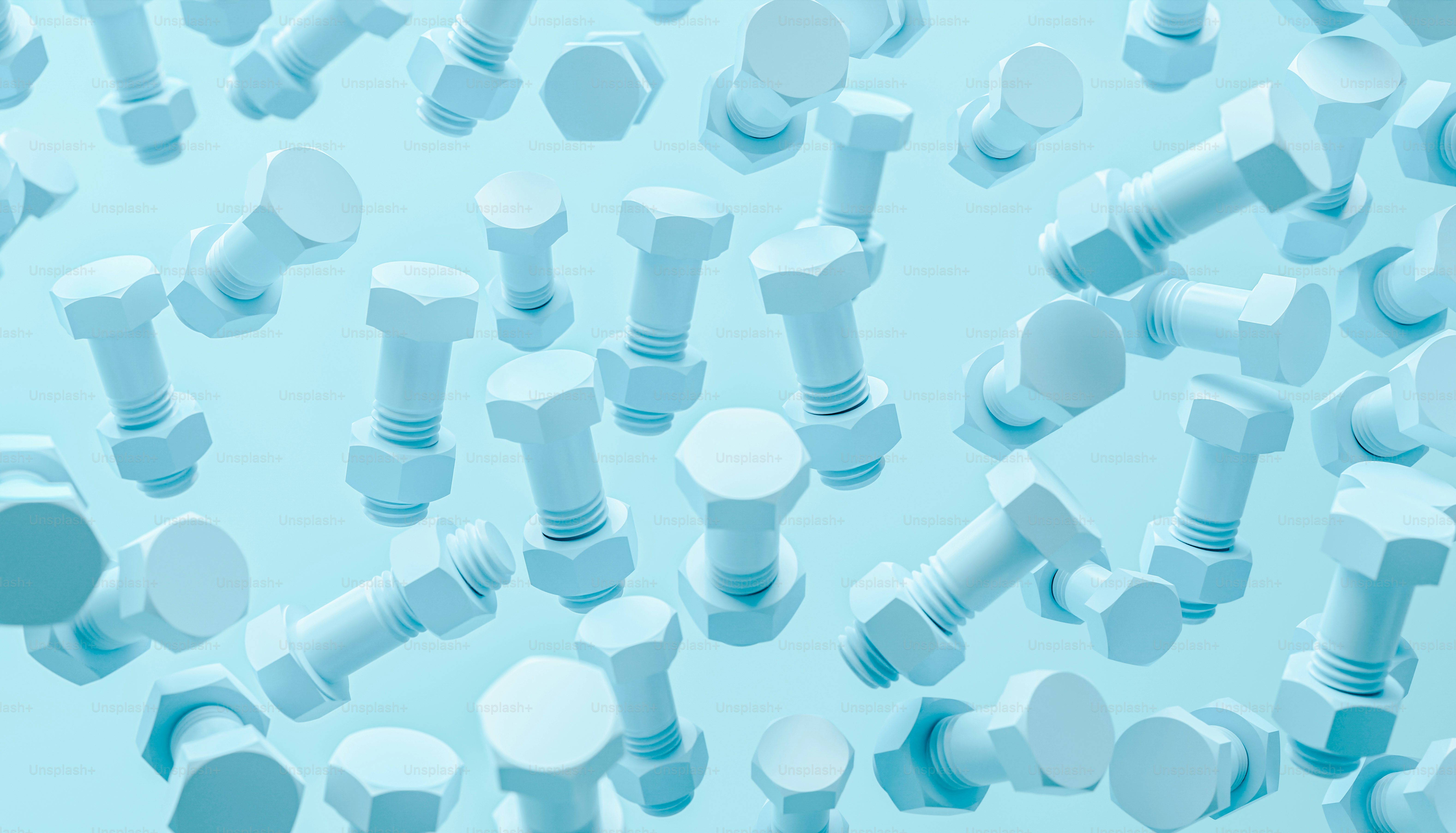 beaucoup de vis et d’écrous sur fond bleu