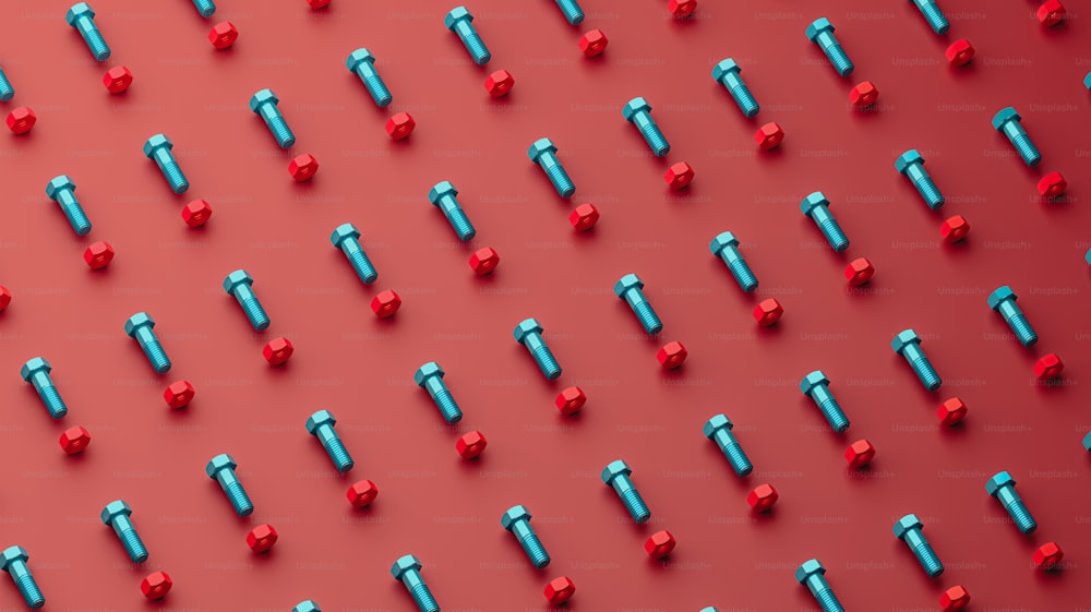 a group of red and blue screws on a red background