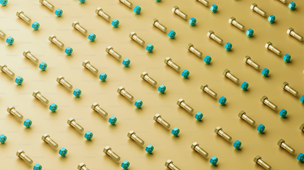 a group of blue and gold screws on a yellow background