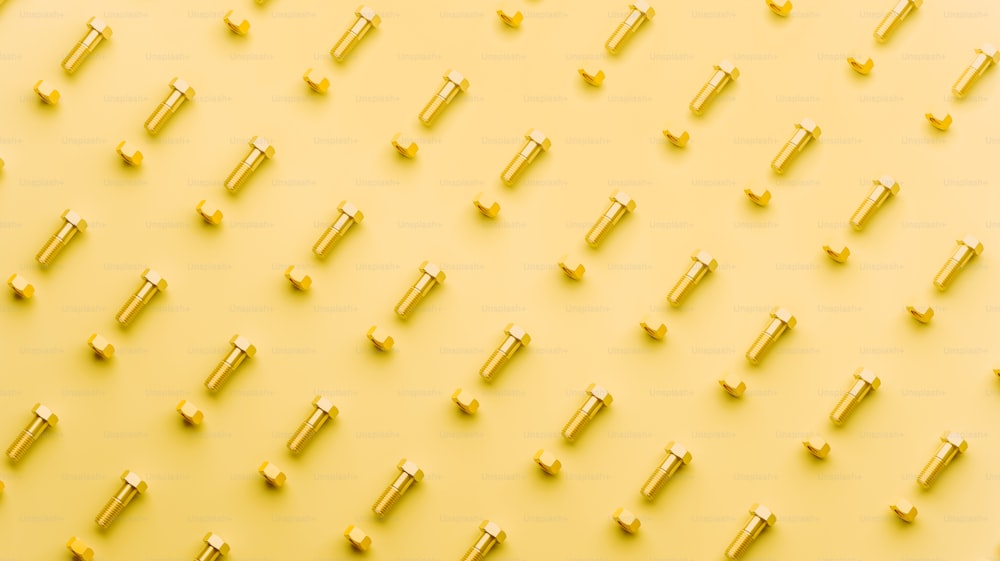 a bunch of screws on a yellow background