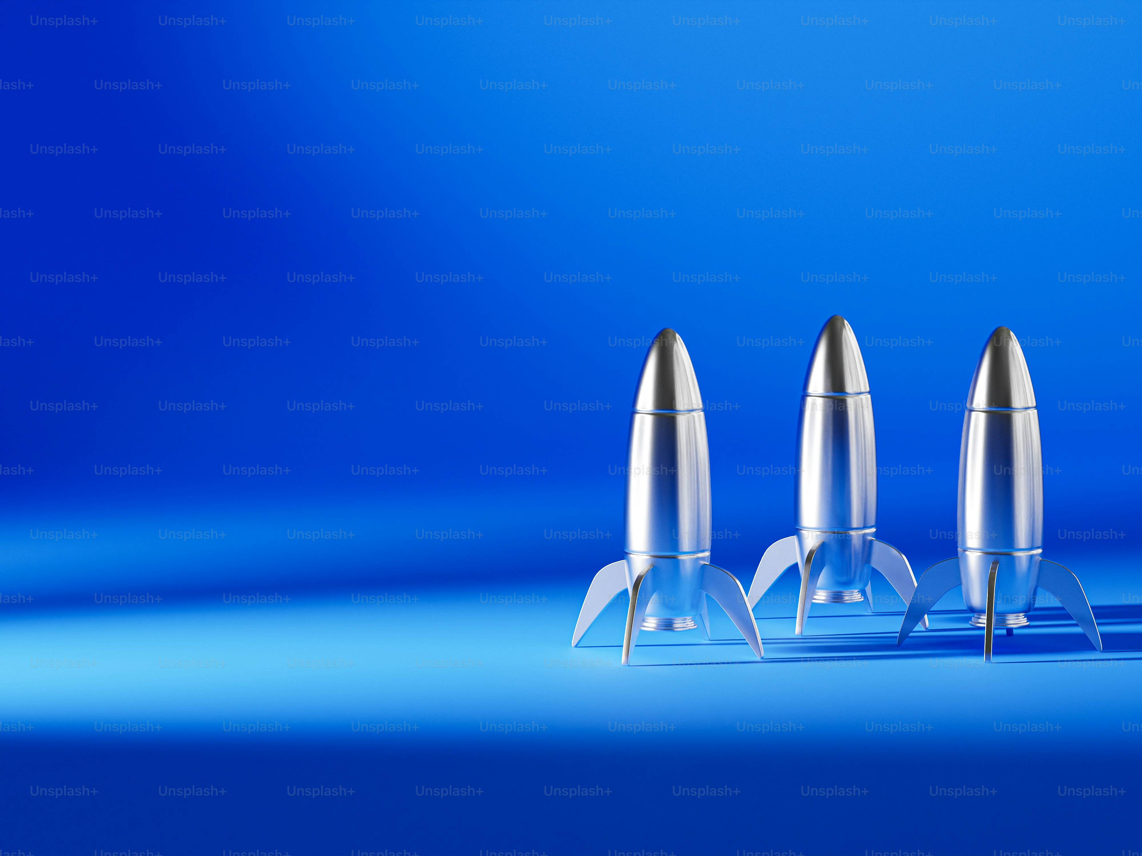 A blue rocket ship sitting on top of a table photo – Technology Image ...