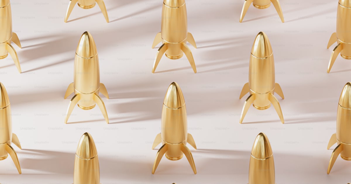 A group of golden rockets sitting on top of each other photo – Golden ...