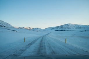 a car driving down a snow covered road