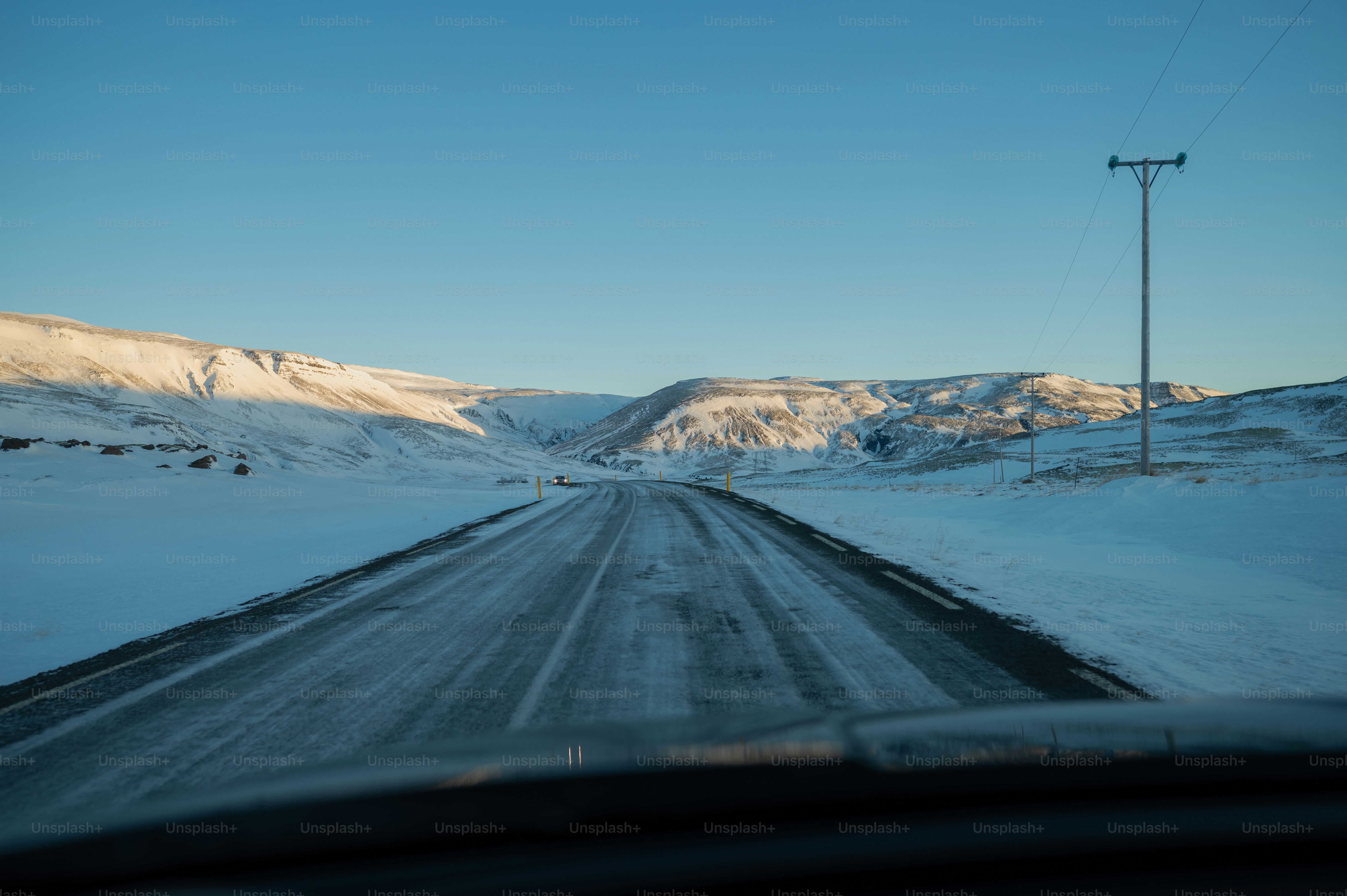 a car driving down a snow covered road