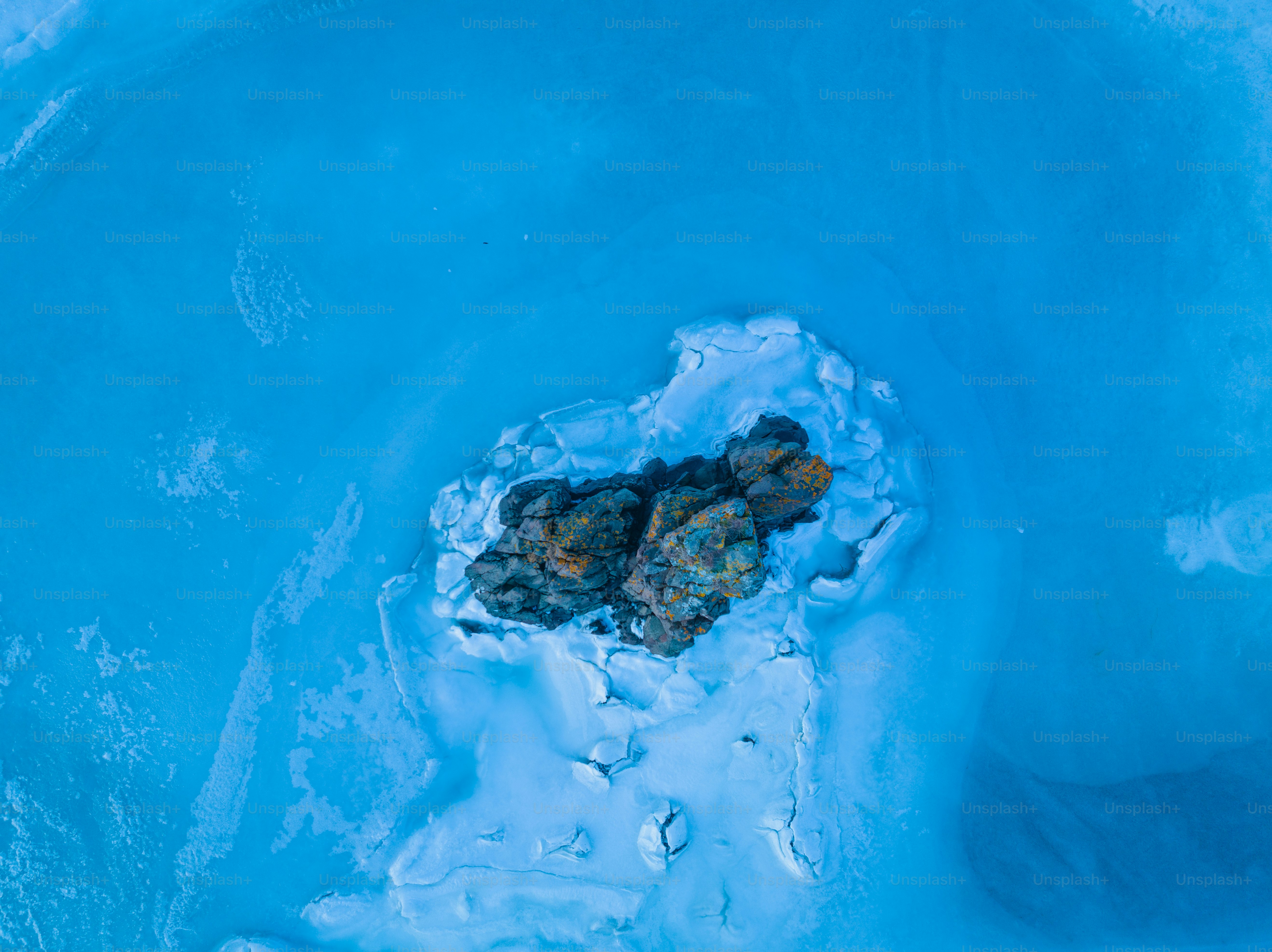 a group of rocks sitting in the middle of some ice
