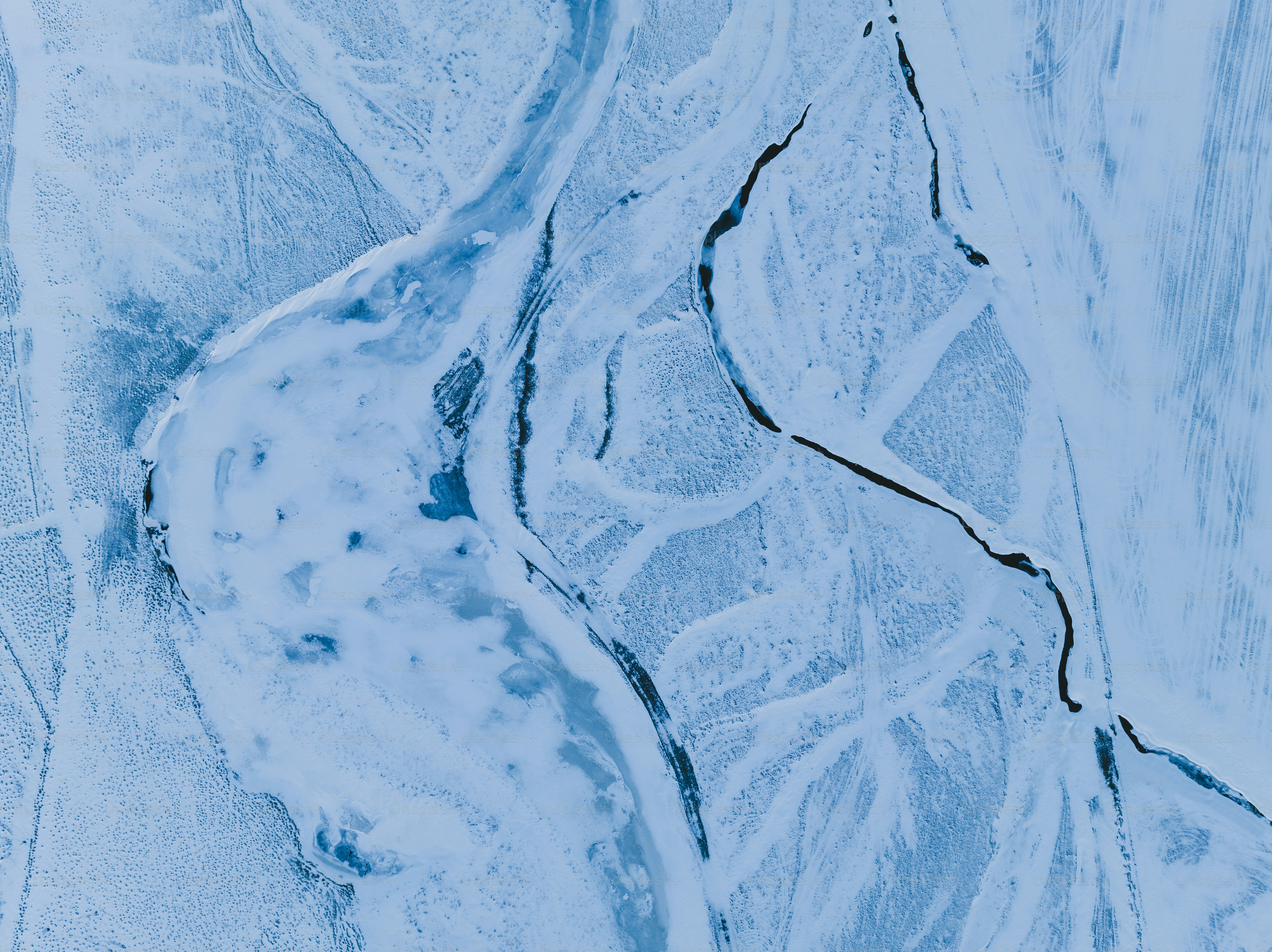 an aerial view of a snow covered landscape