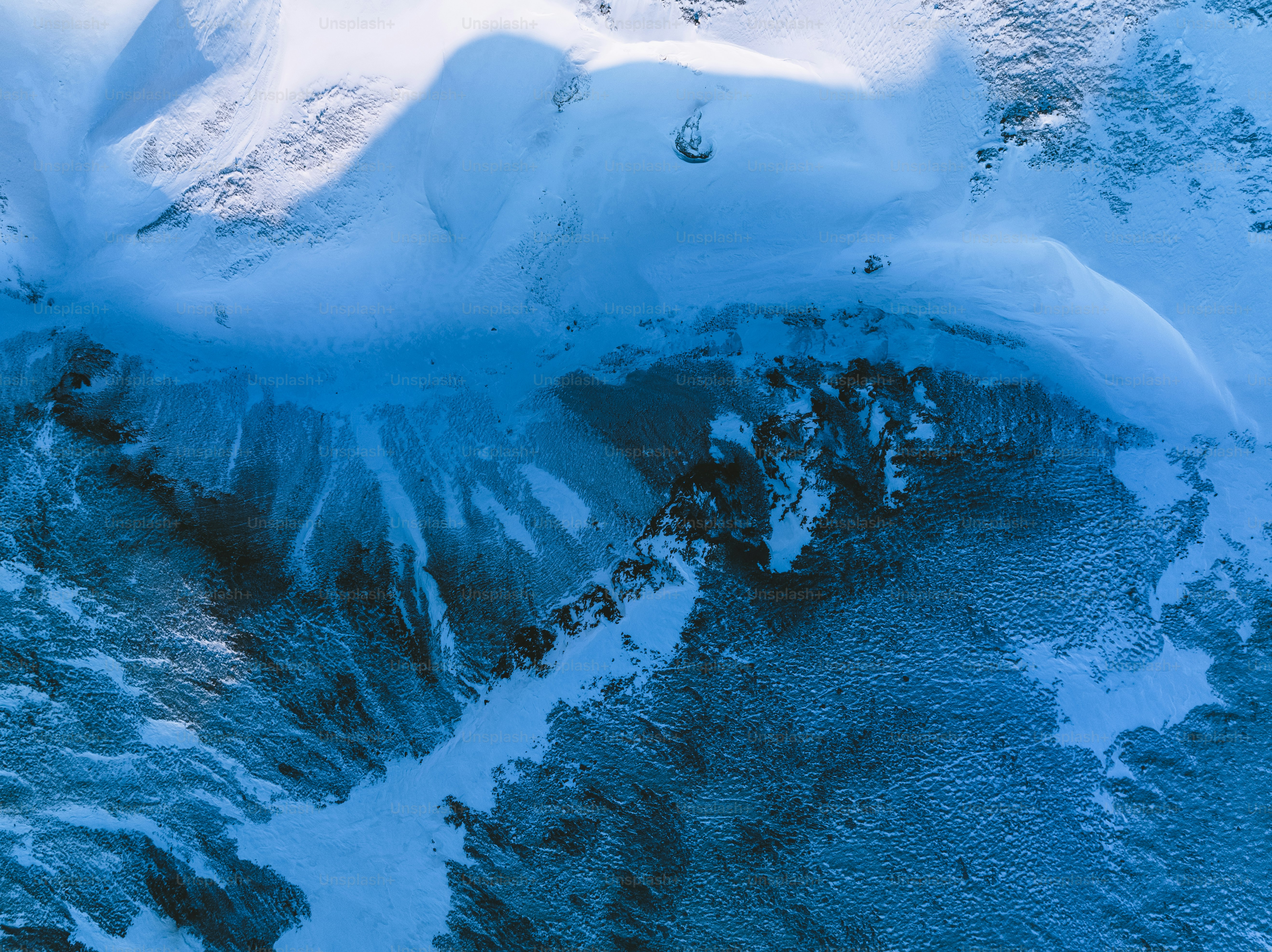 an aerial view of a snow covered mountain