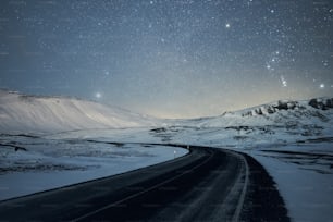 a road in the middle of a snowy landscape