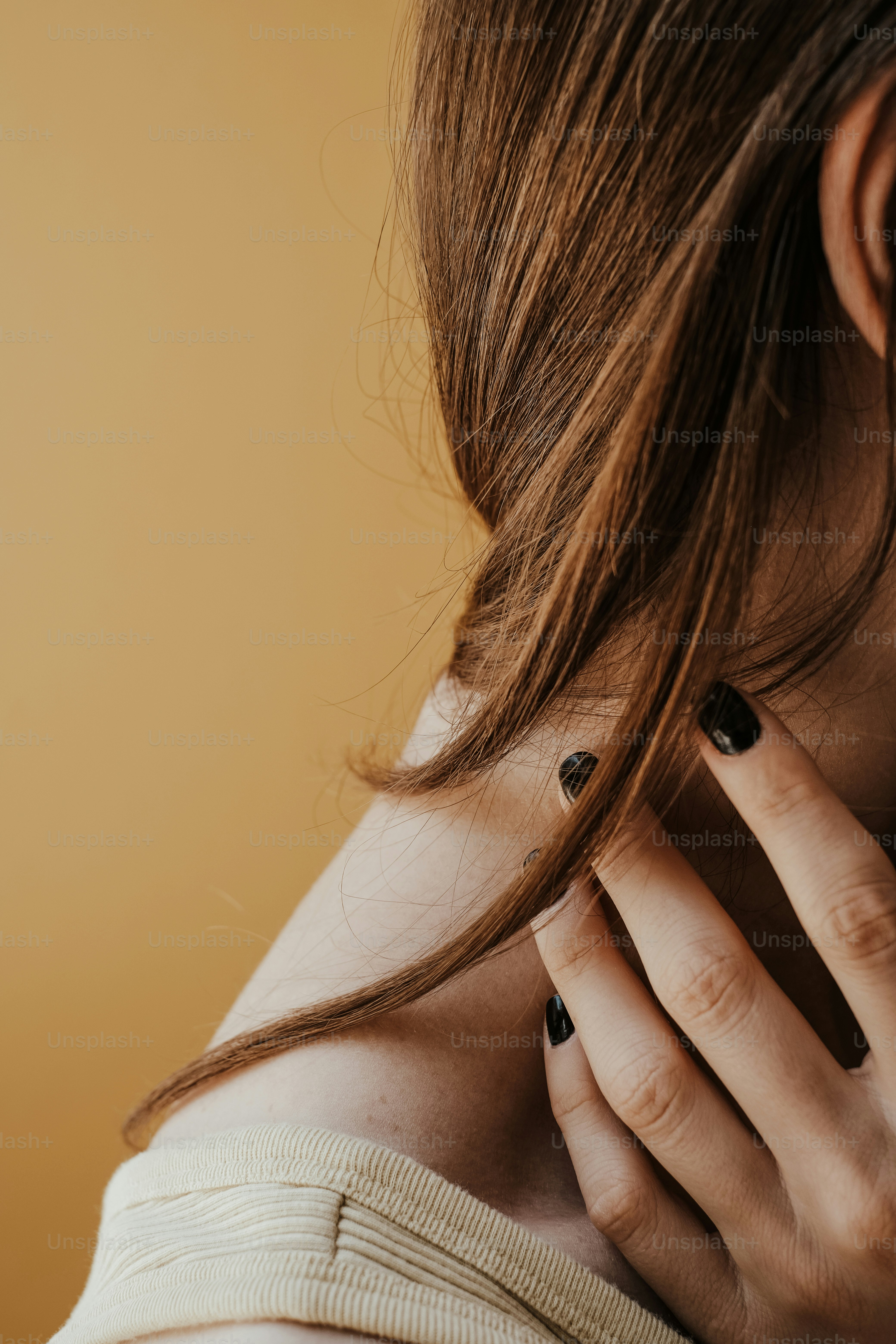a close up of a person holding a cell phone to their ear
