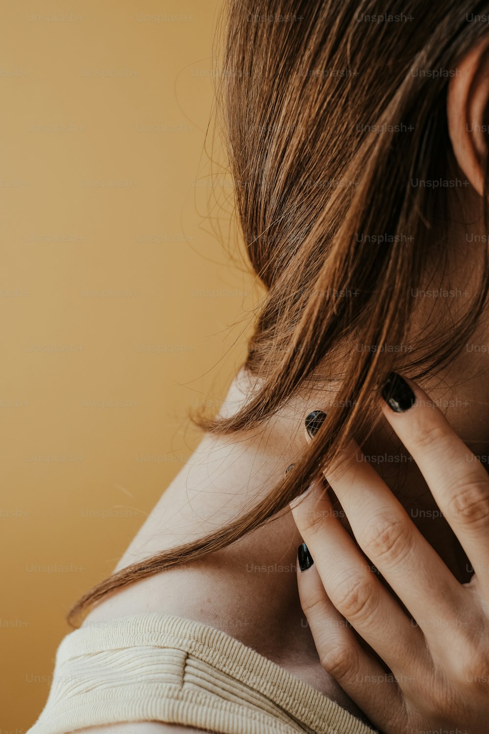 a close up of a person holding a cell phone to their ear