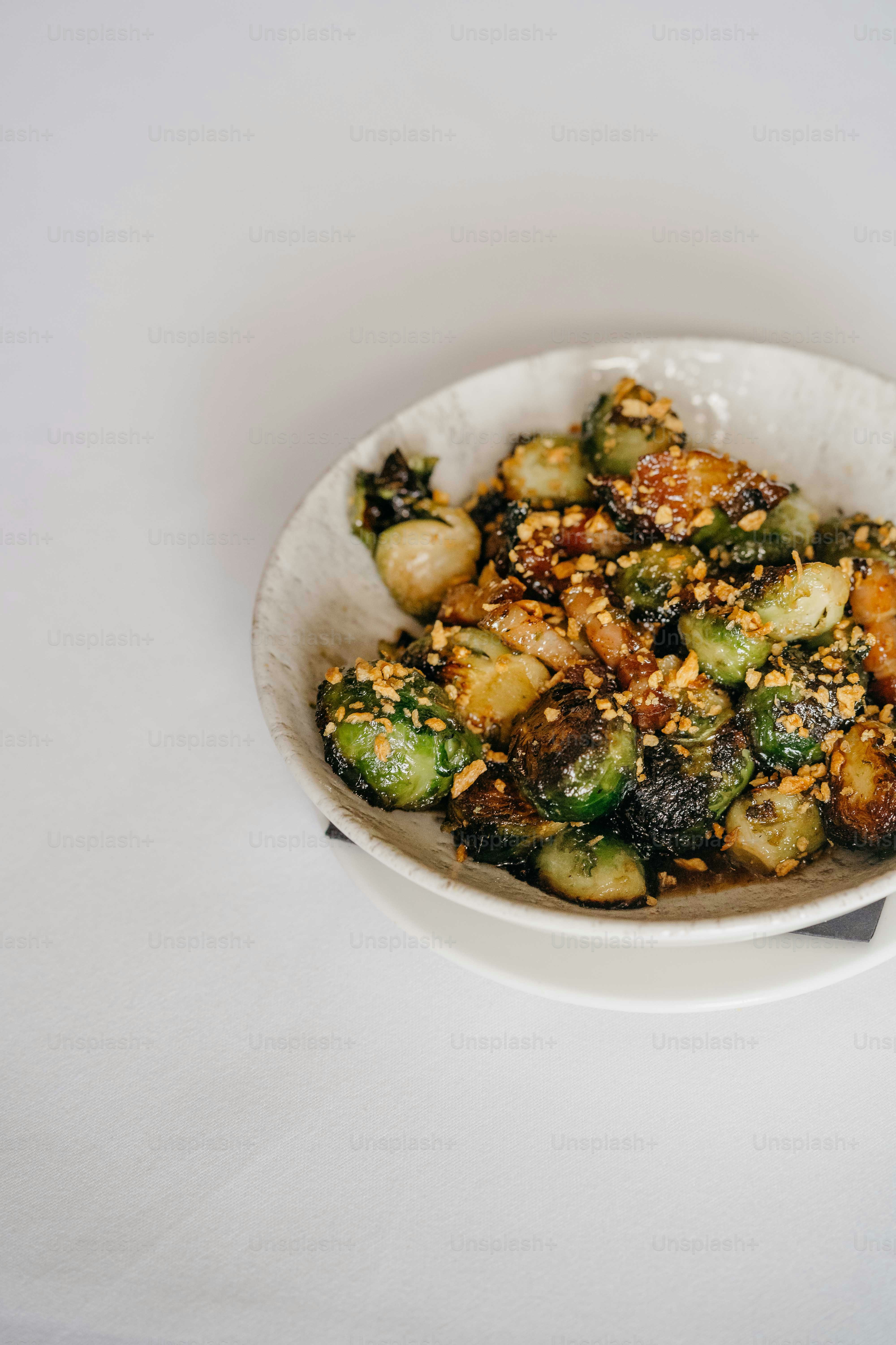 a white bowl filled with vegetables on top of a table