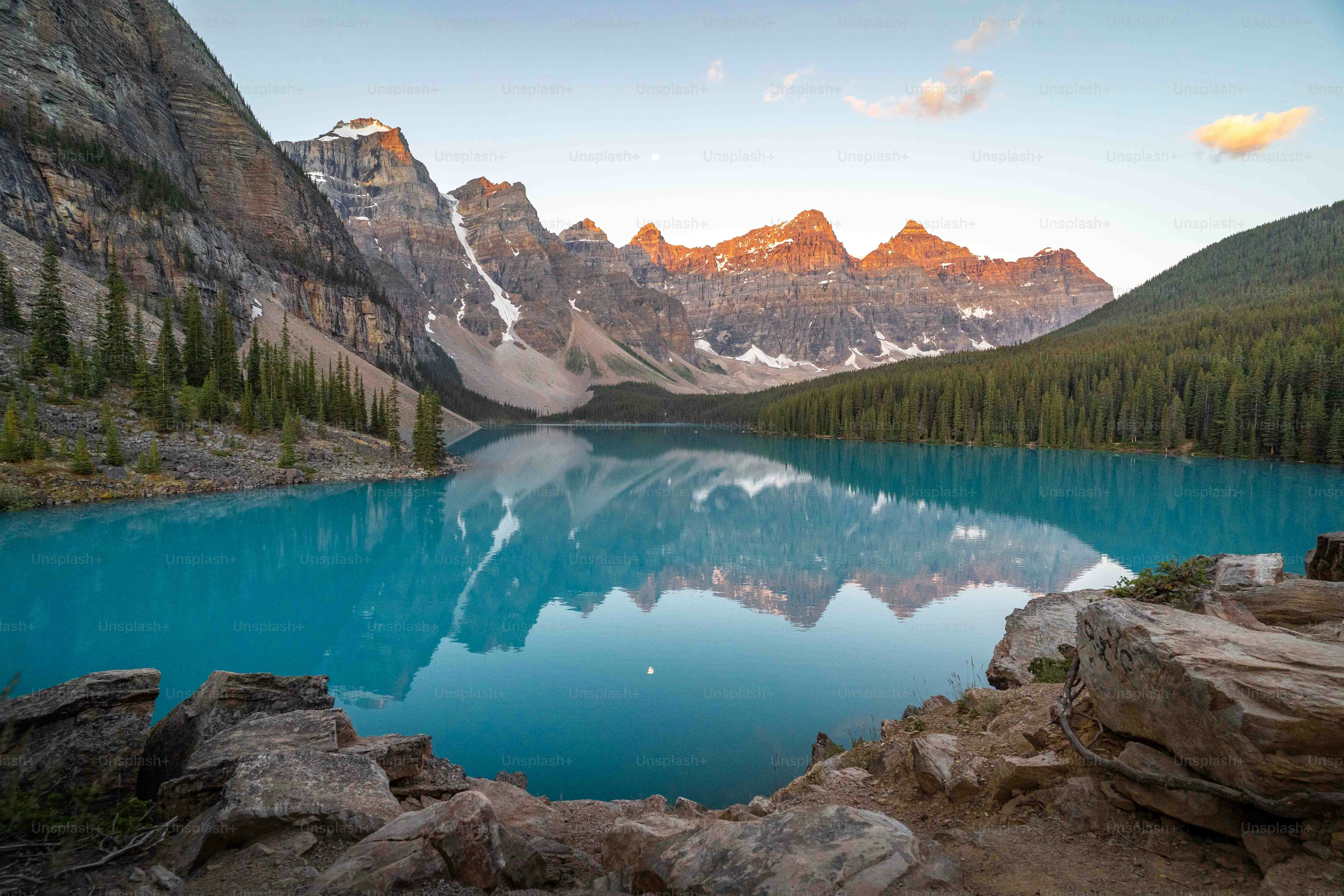 a blue lake surrounded by mountains and trees