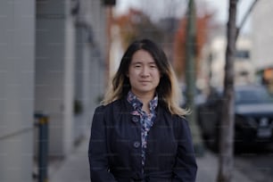 a woman standing on the side of a street