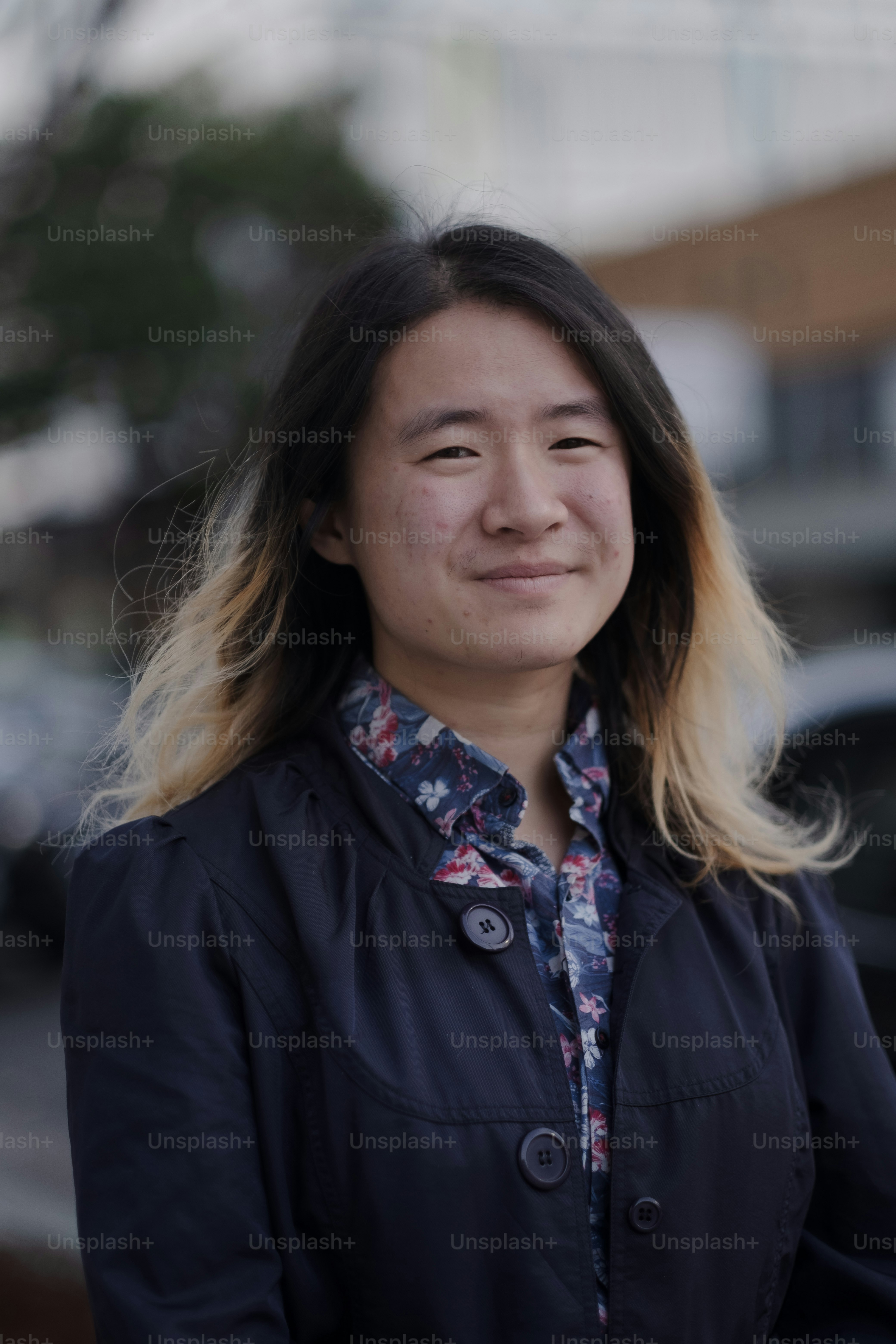 A woman with long hair standing in front of a building photo – Human ...