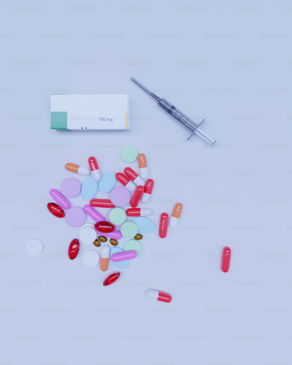 a pile of pills next to a syringe on a table