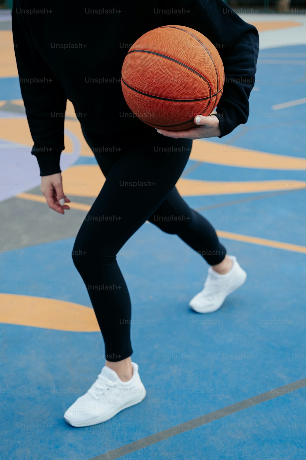 a person holding a basketball on a court
