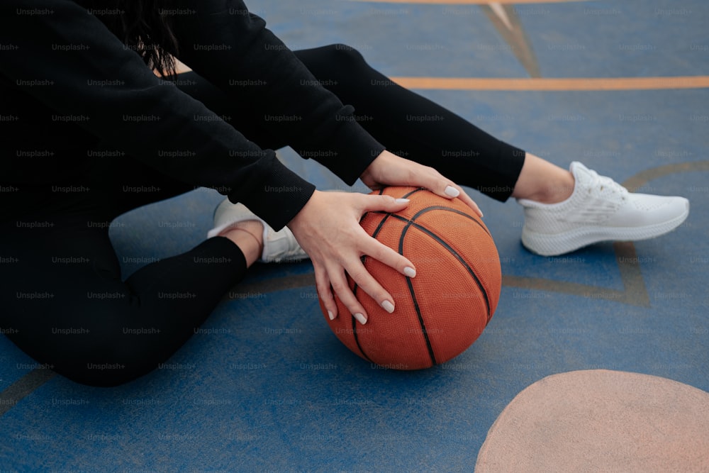 a close up of a person holding a basketball