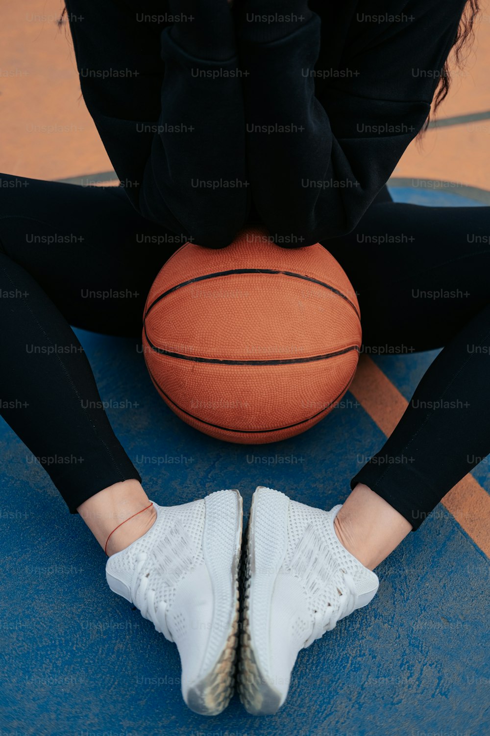un primo piano dei piedi di una persona con un pallone da basket
