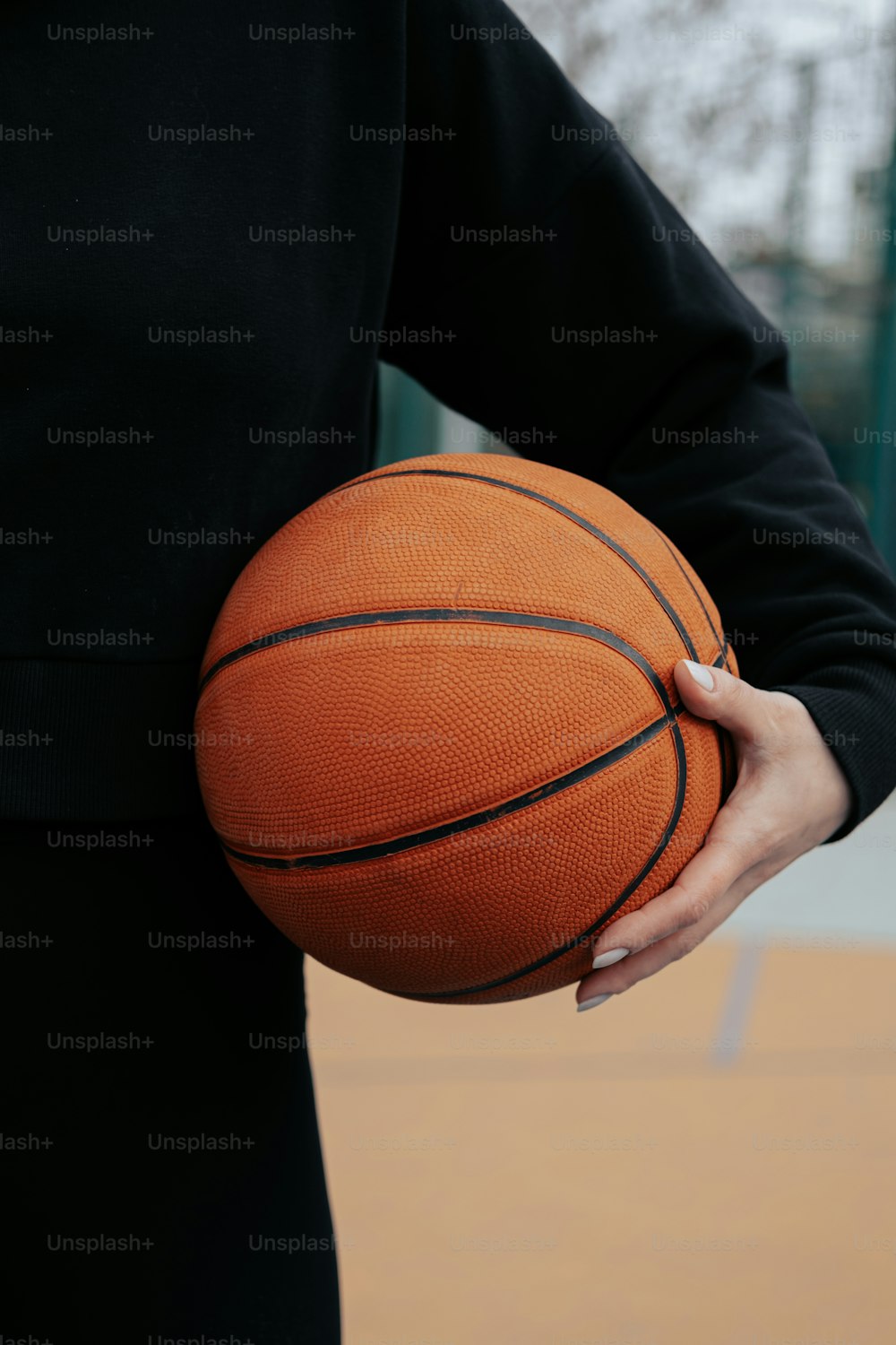 a person holding a basketball in their hands