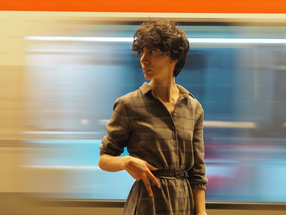 a woman standing in front of a train