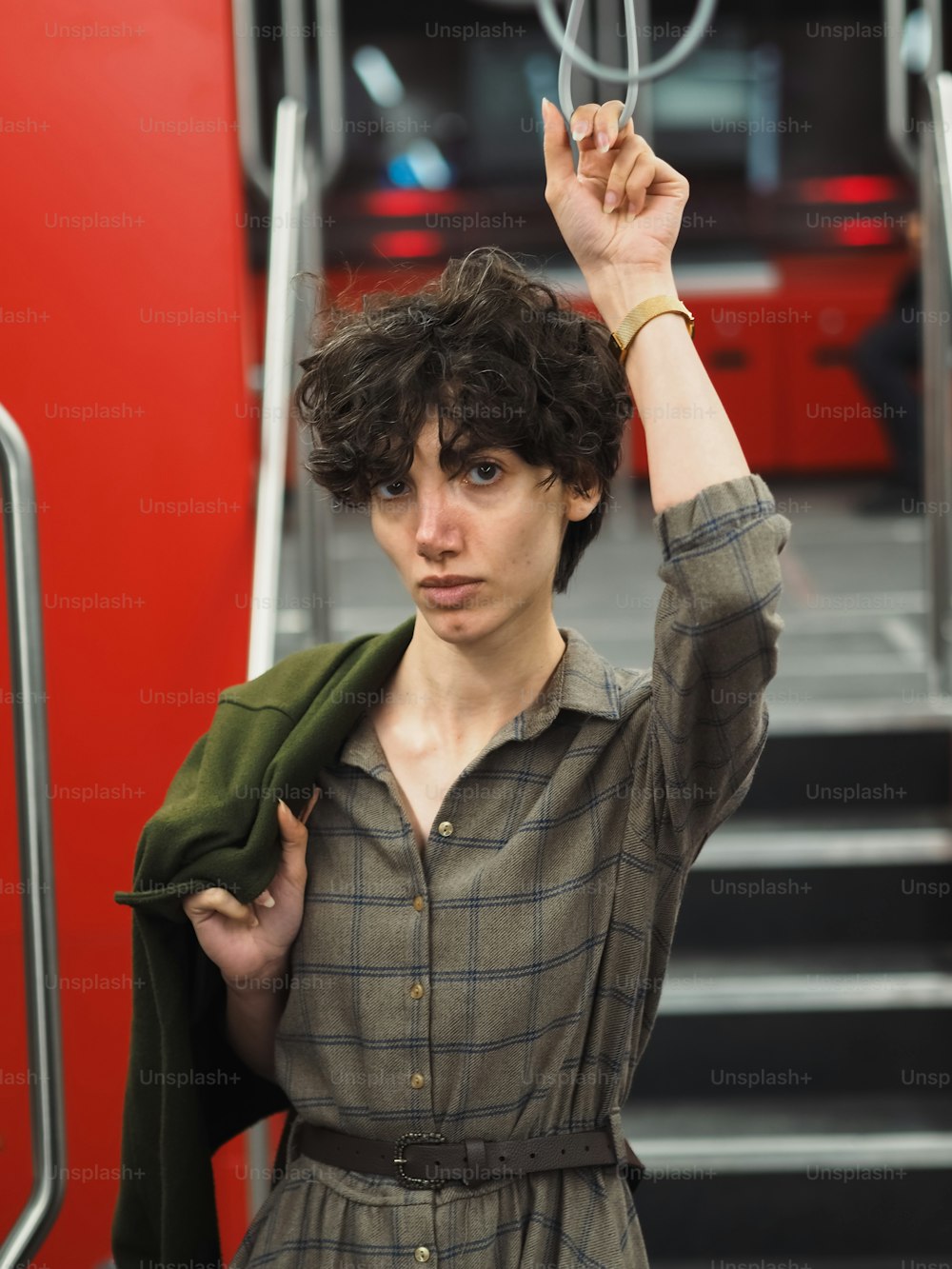 a woman holding a green jacket over her head