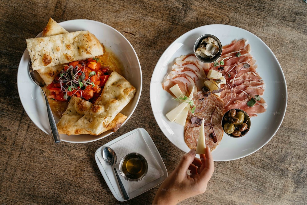 zwei Teller mit Essen auf einem Holztisch