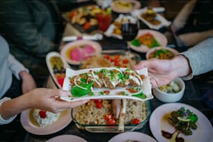 a group of people holding plates of food