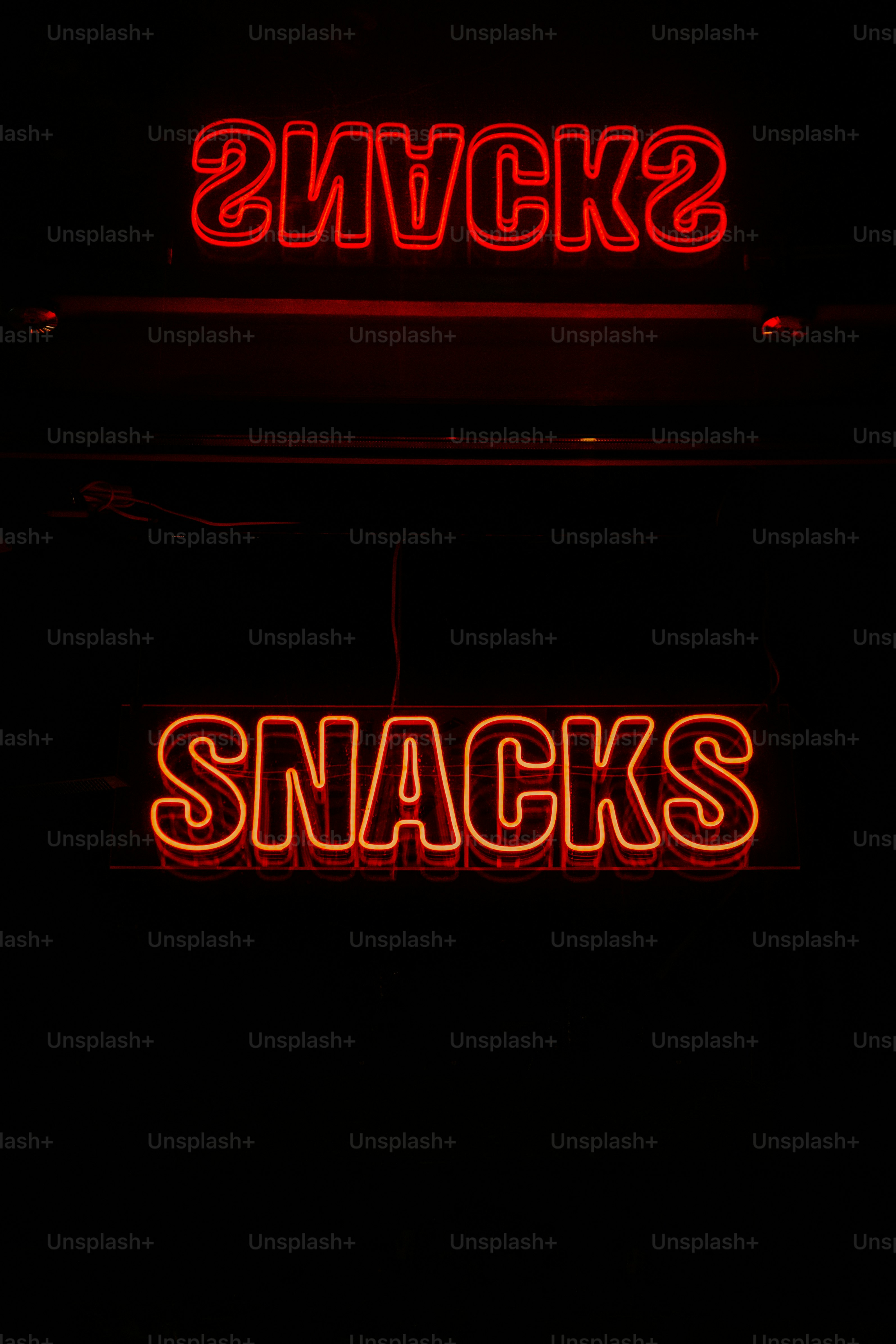 a couple of neon signs that are on the side of a building