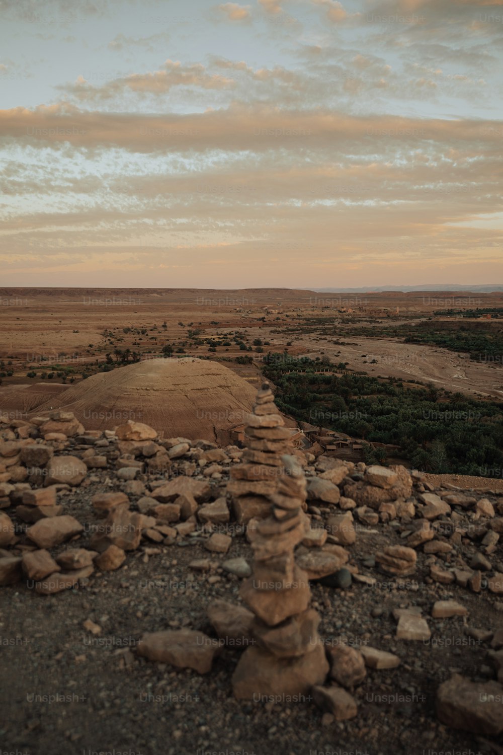 a pile of rocks sitting on top of a dirt field