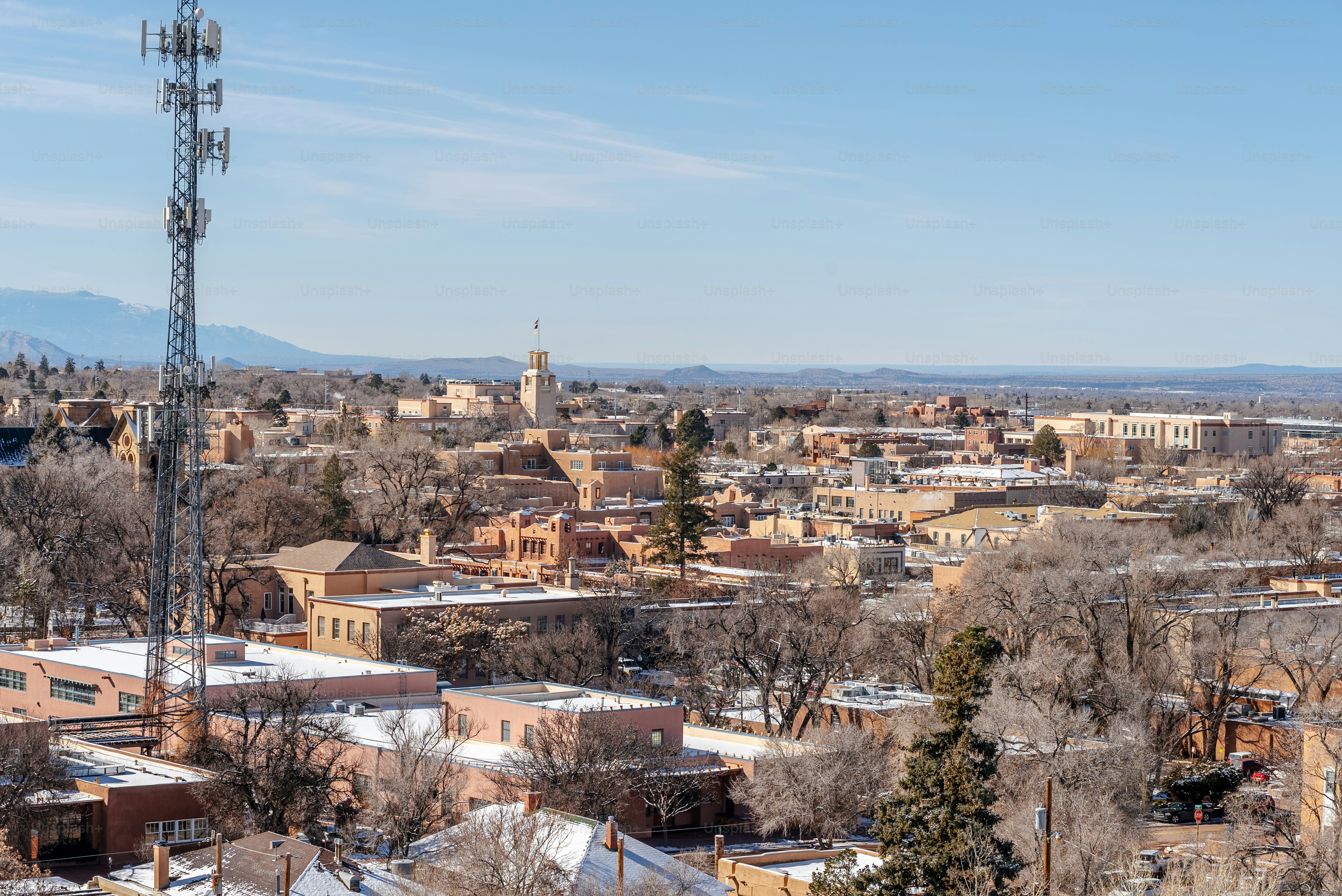 a view of a city with a radio tower in the foreground