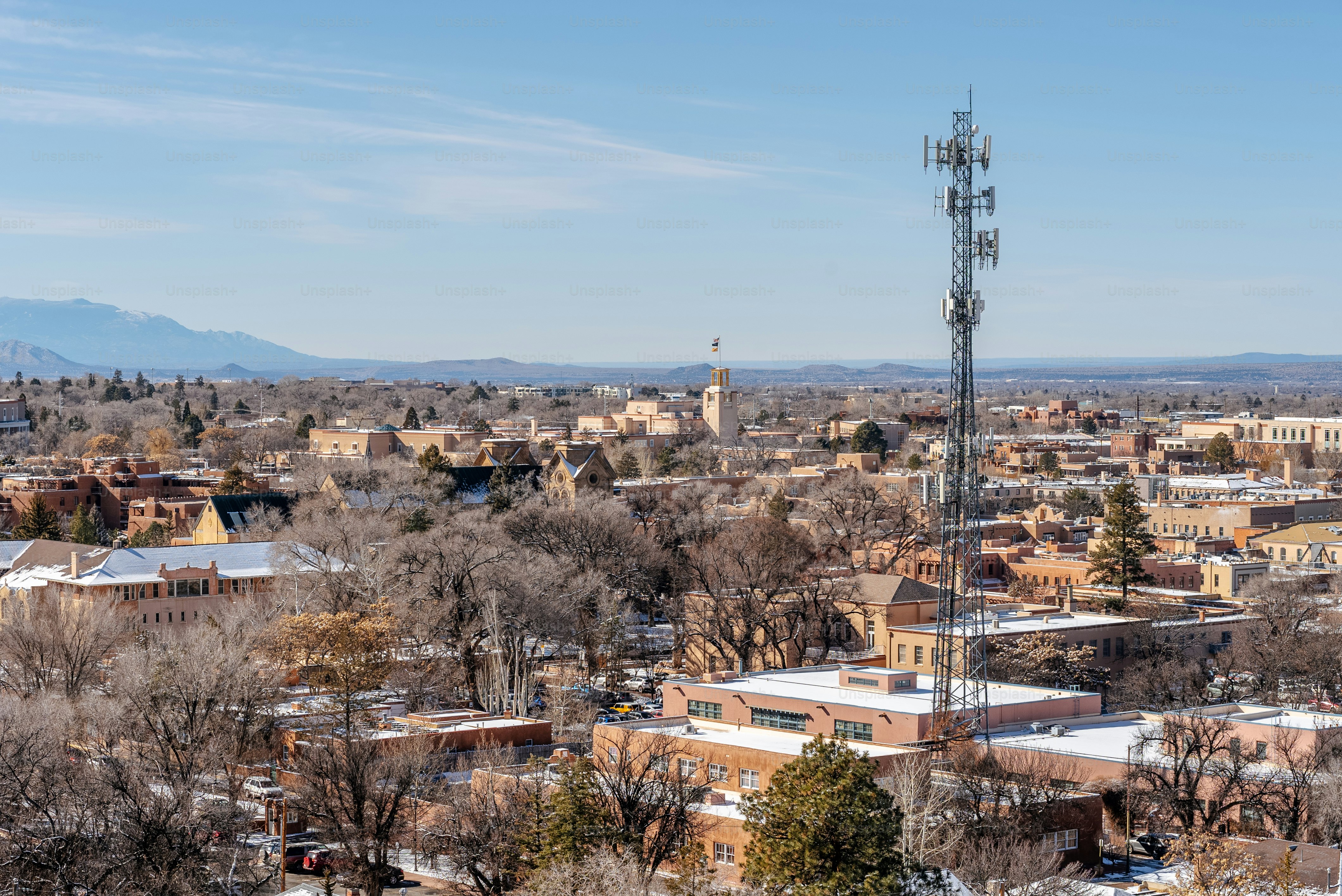 a view of a city with a radio tower in the foreground