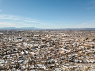 an aerial view of a city with snow on the ground