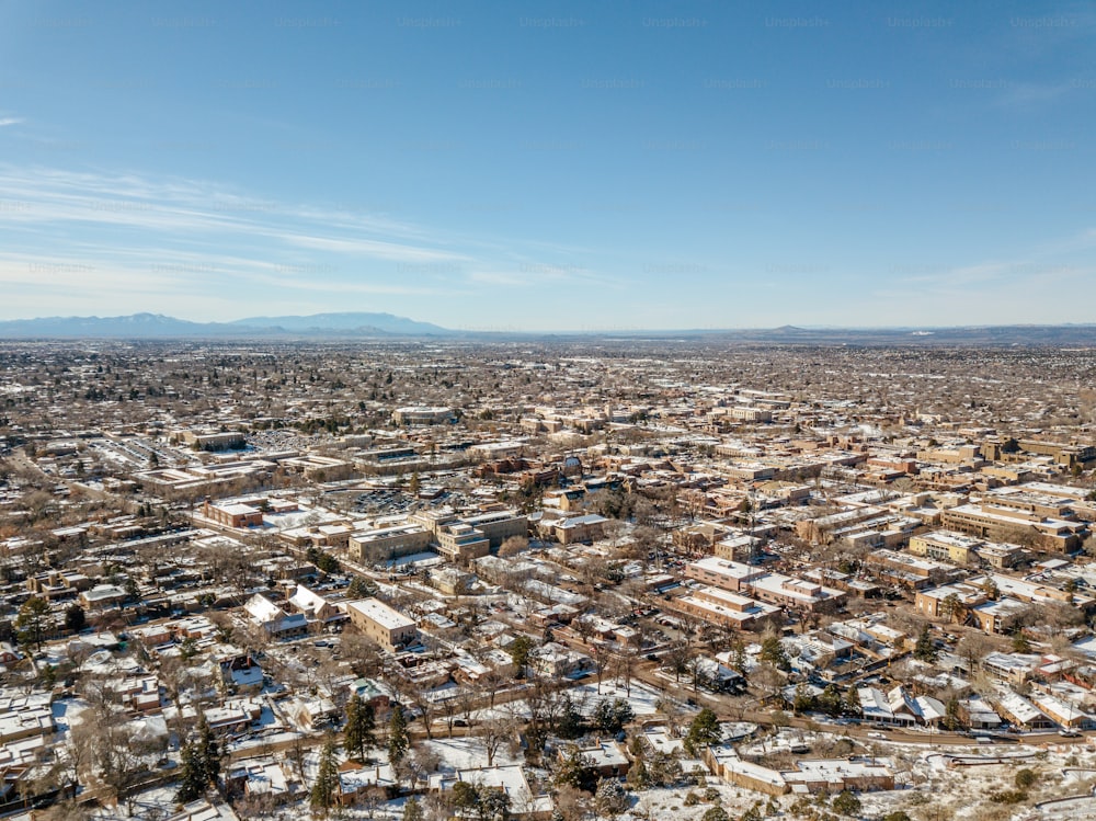 an aerial view of a city with snow on the ground