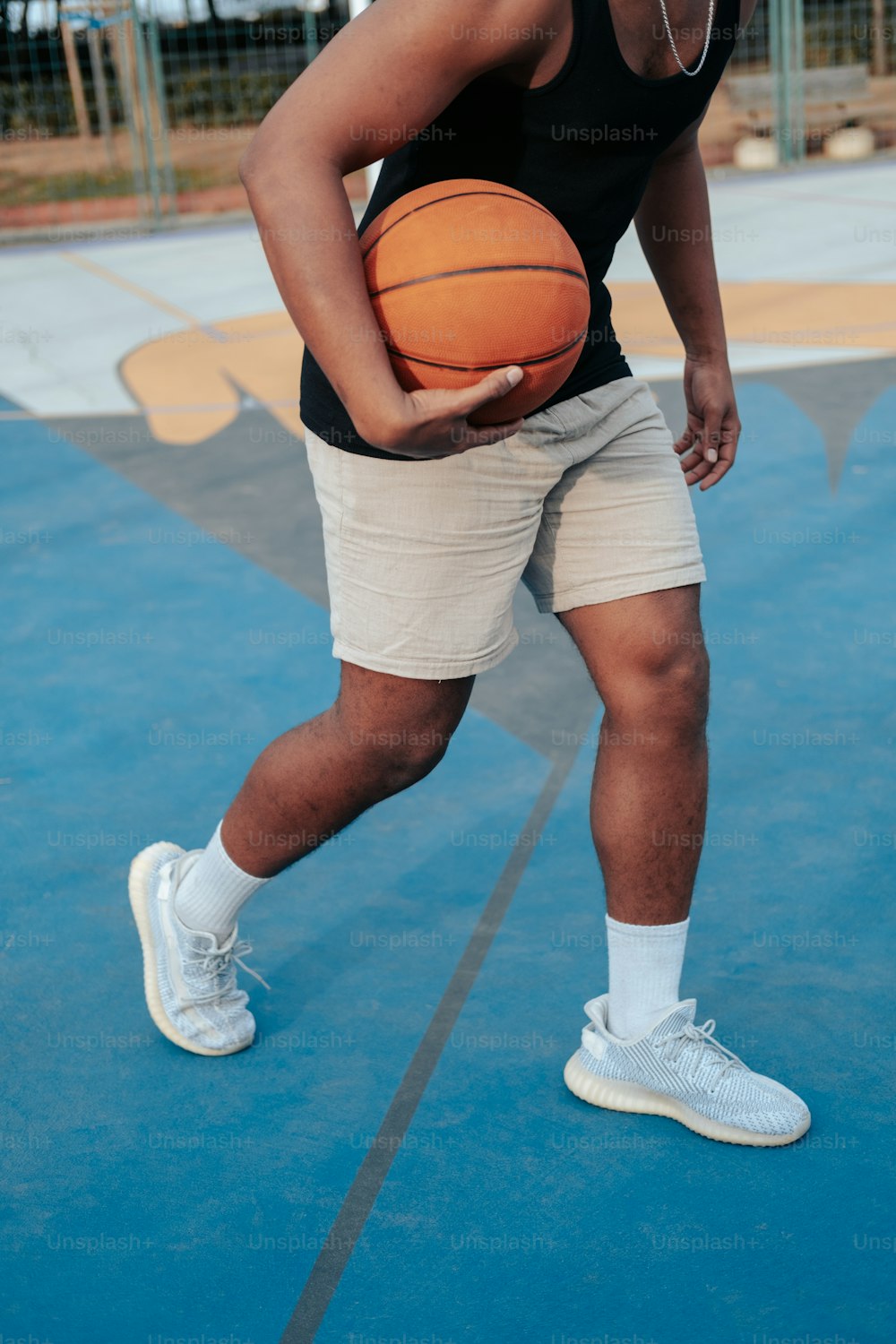 a man holding a basketball on a court