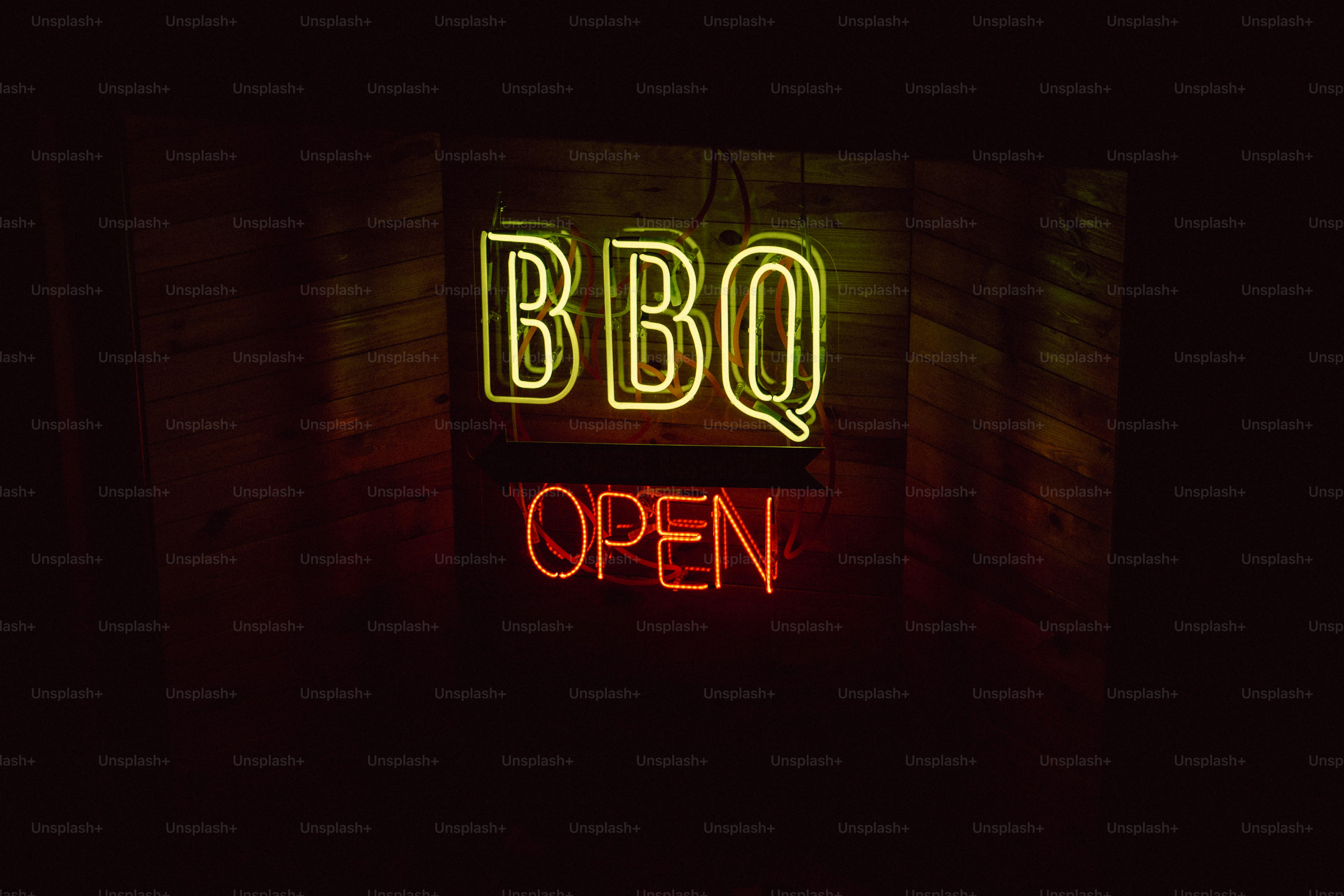Eine Leuchtreklame mit der Aufschrift BBQ Open in a Dark Room