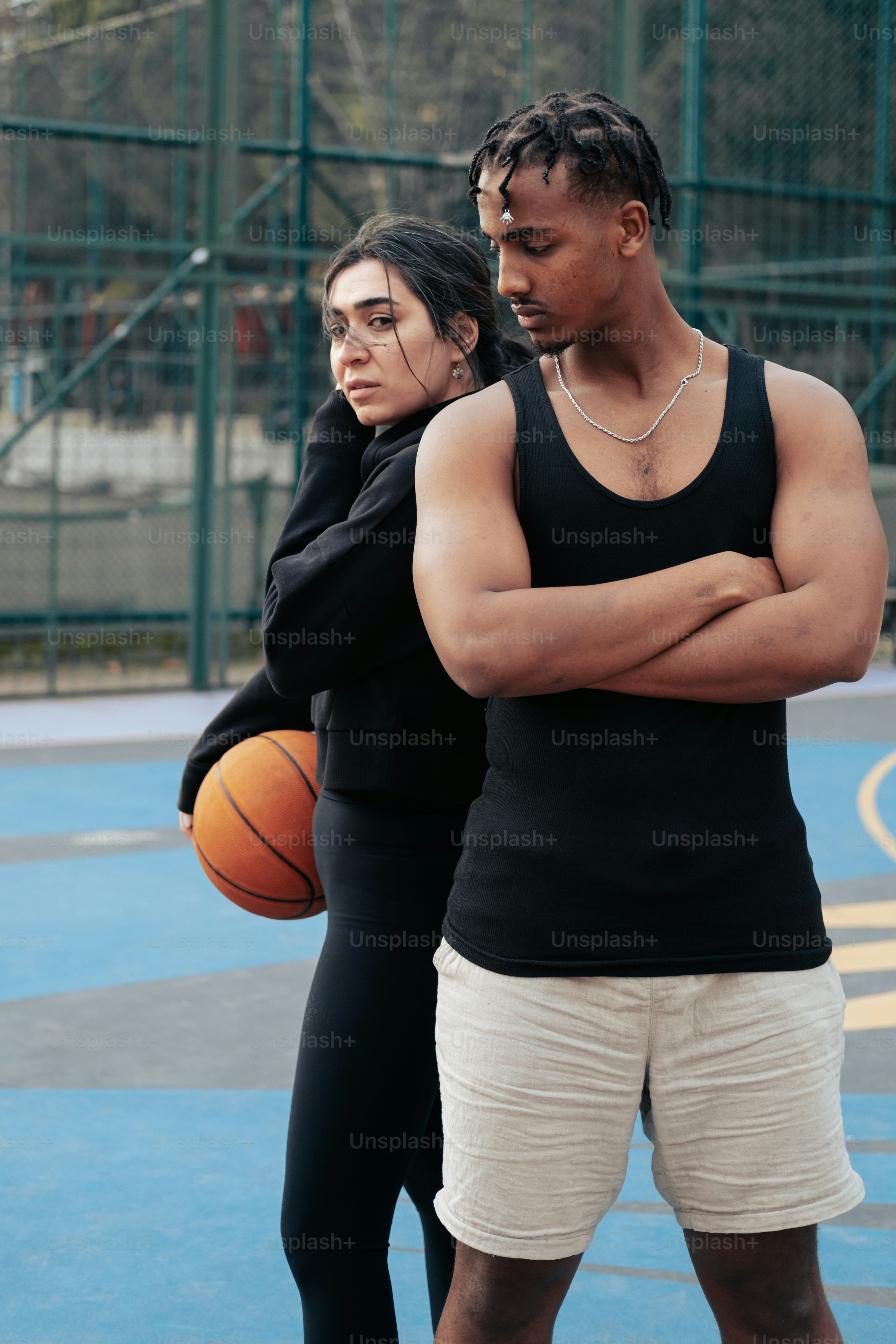 a man and a woman standing on a basketball court