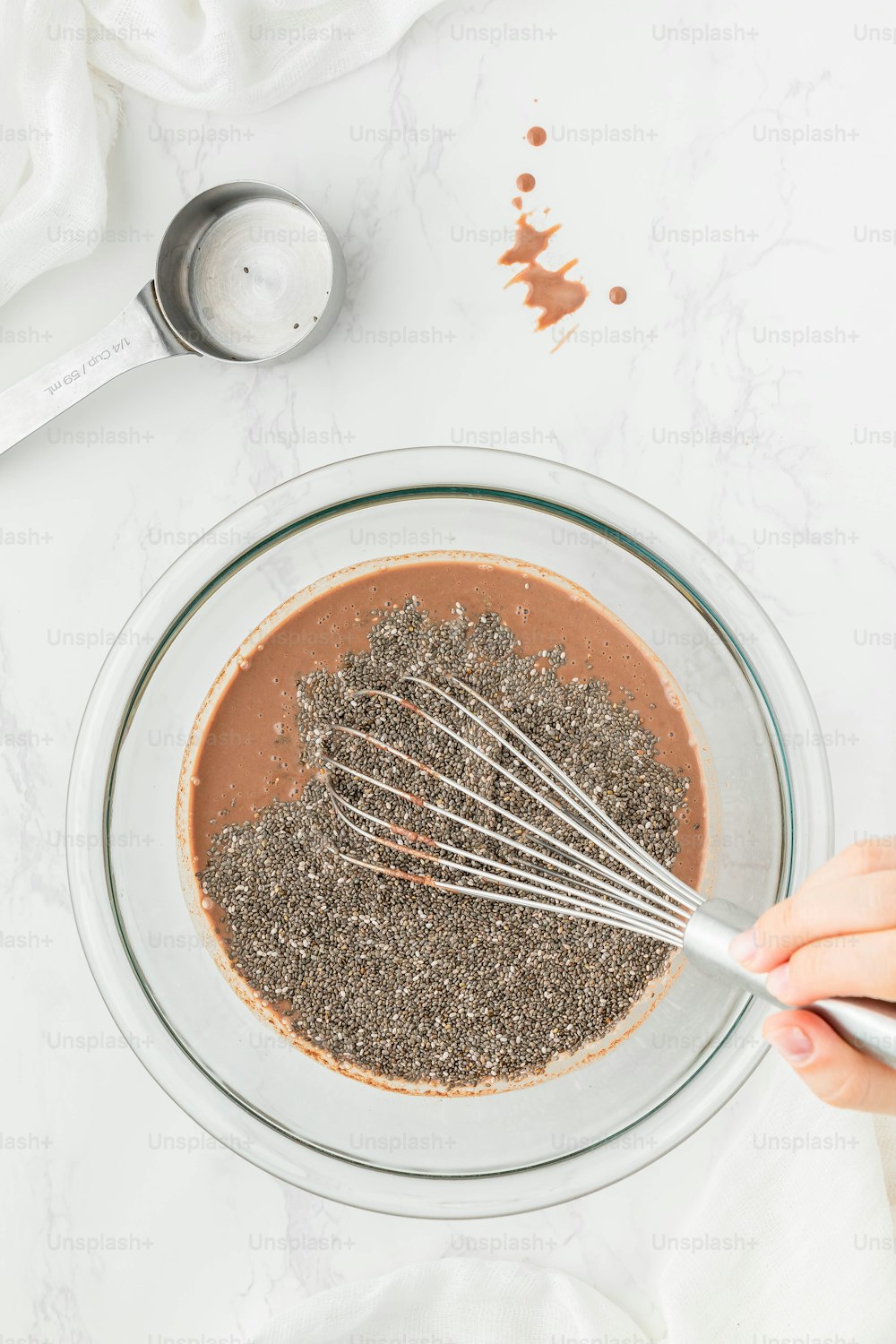 a person whisking chia seeds in a bowl