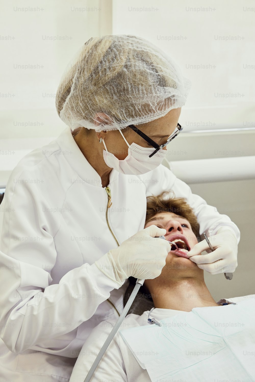 a person in a white lab coat and a person in a white mask