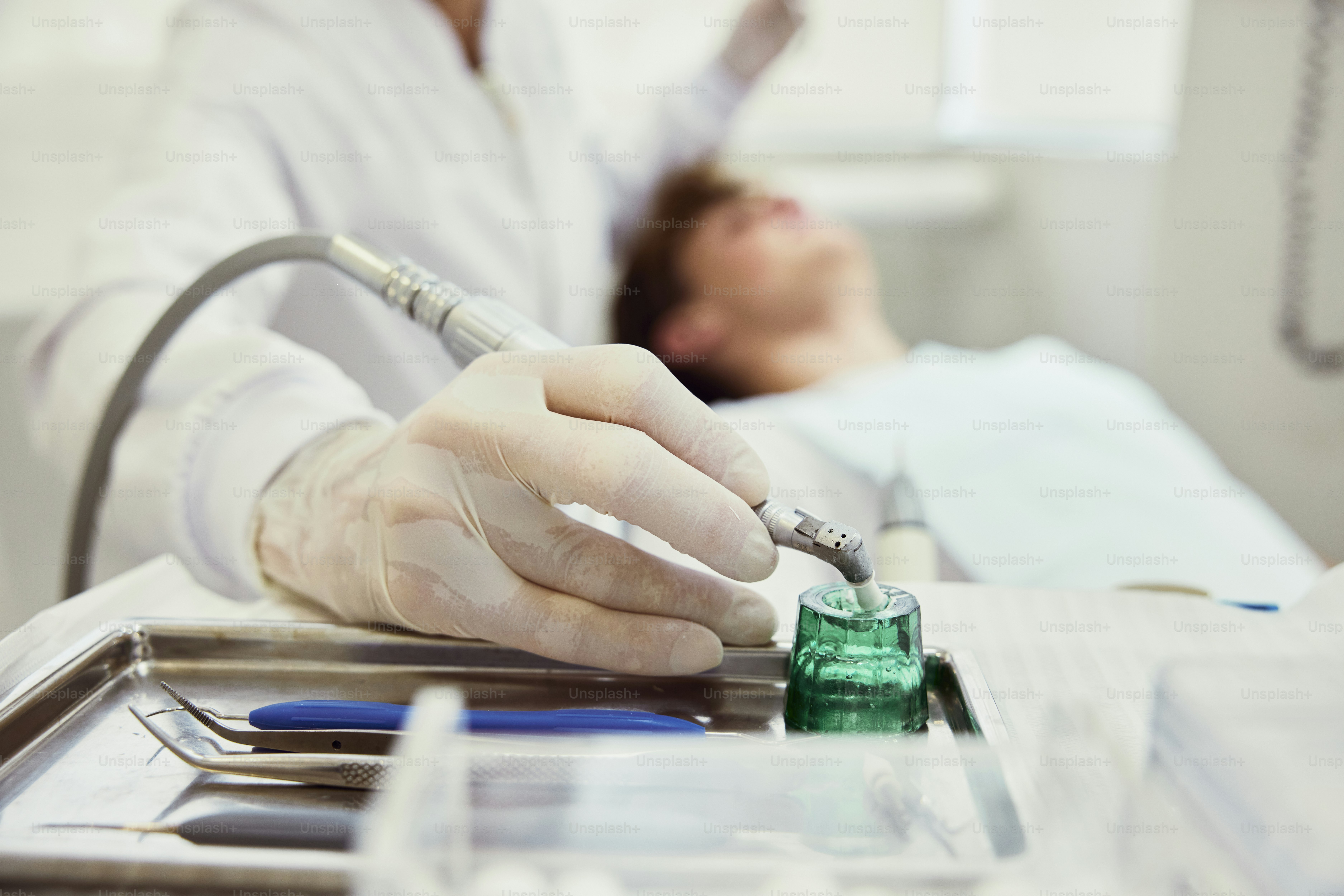 a person in a hospital bed with a green bottle