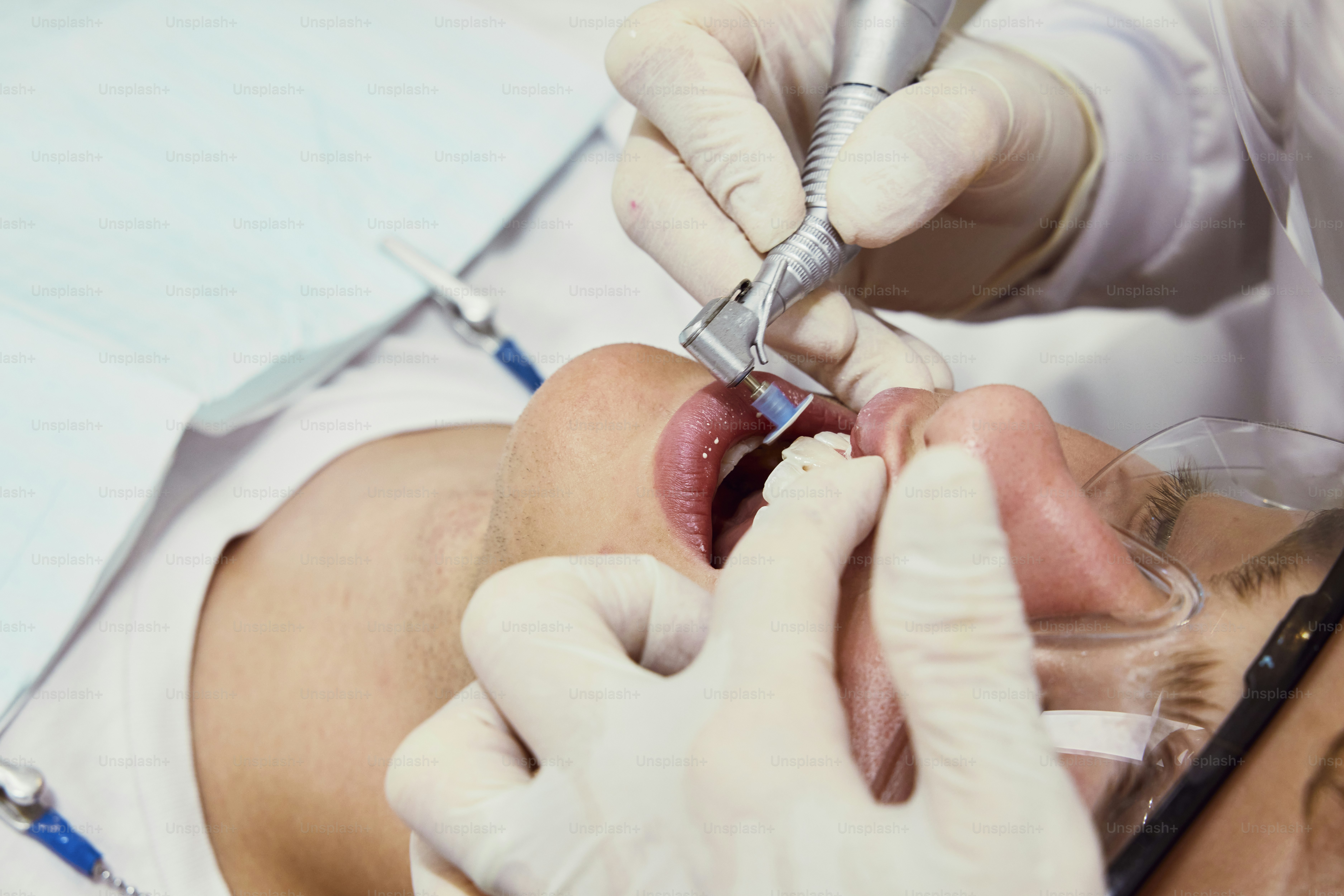 a man getting his teeth checked by a dentist