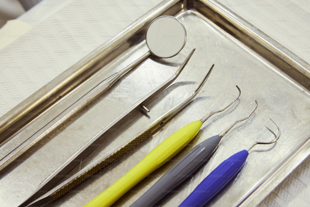 a metal tray with three different tools on it