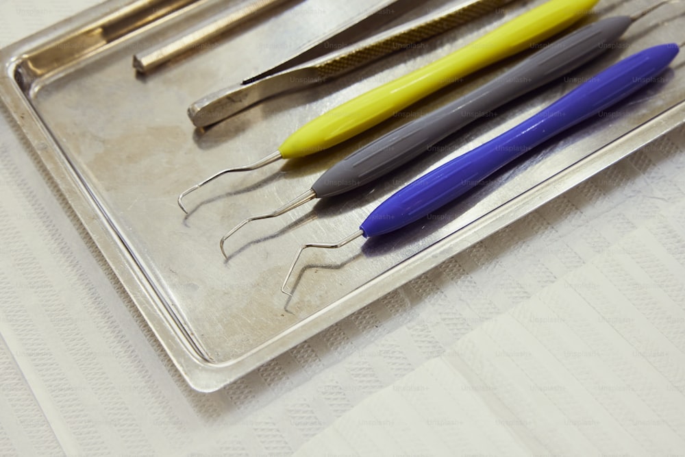 a tray that has some pens and scissors on it