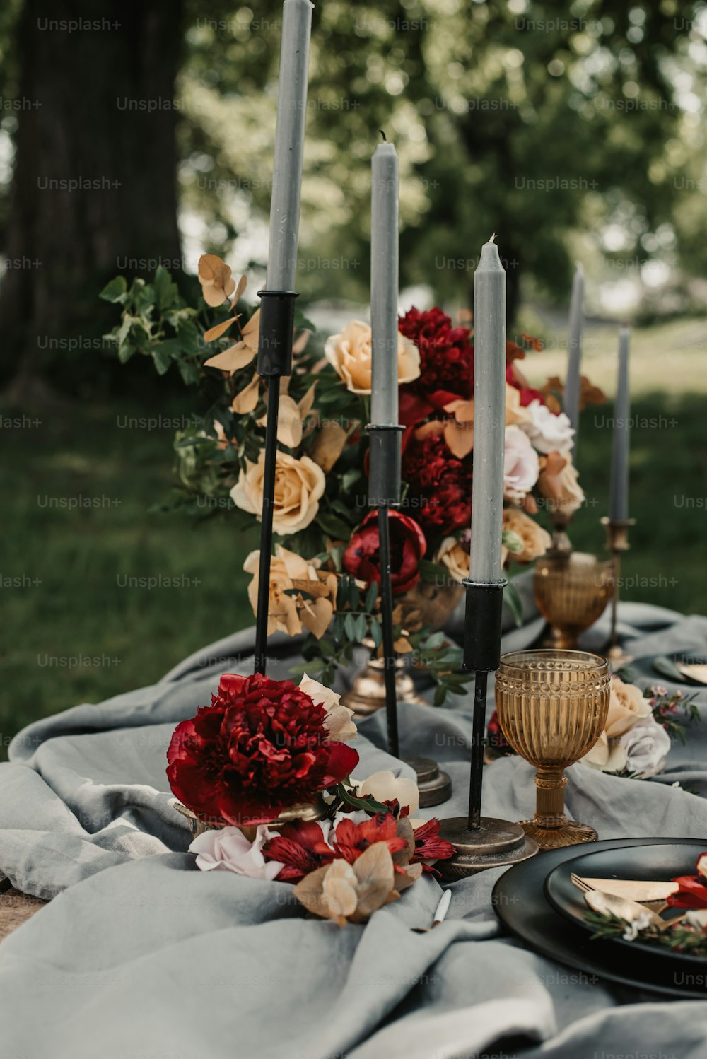 a table topped with candles and plates of food