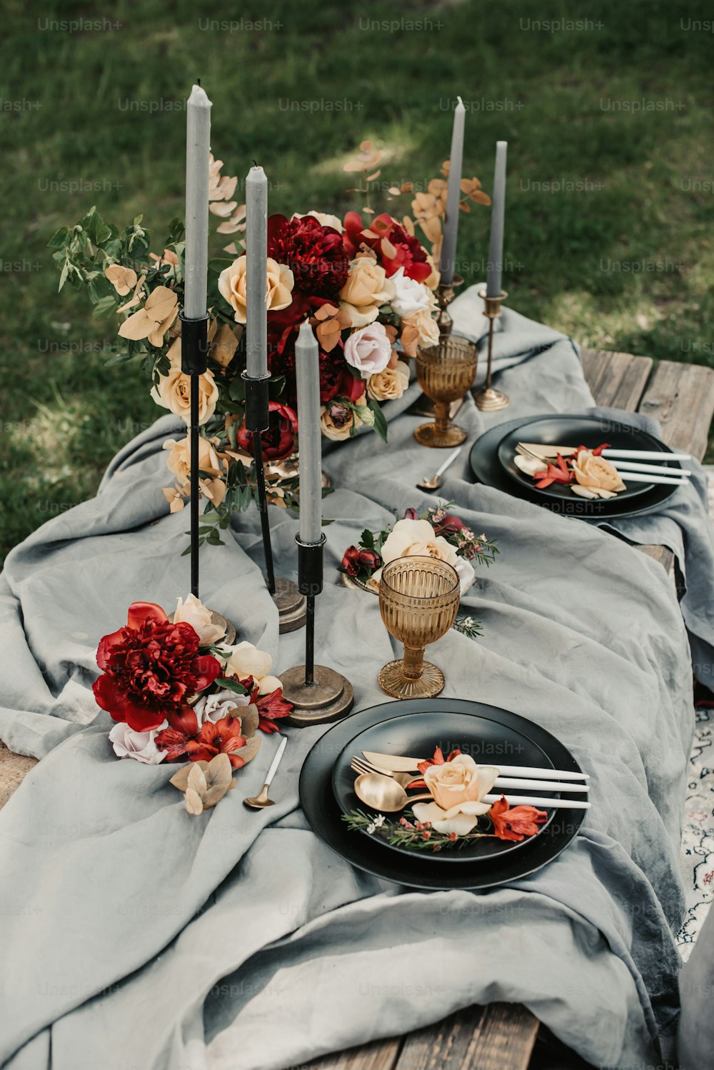 ein Tisch mit schwarzen Tellern, die mit Blumen bedeckt sind