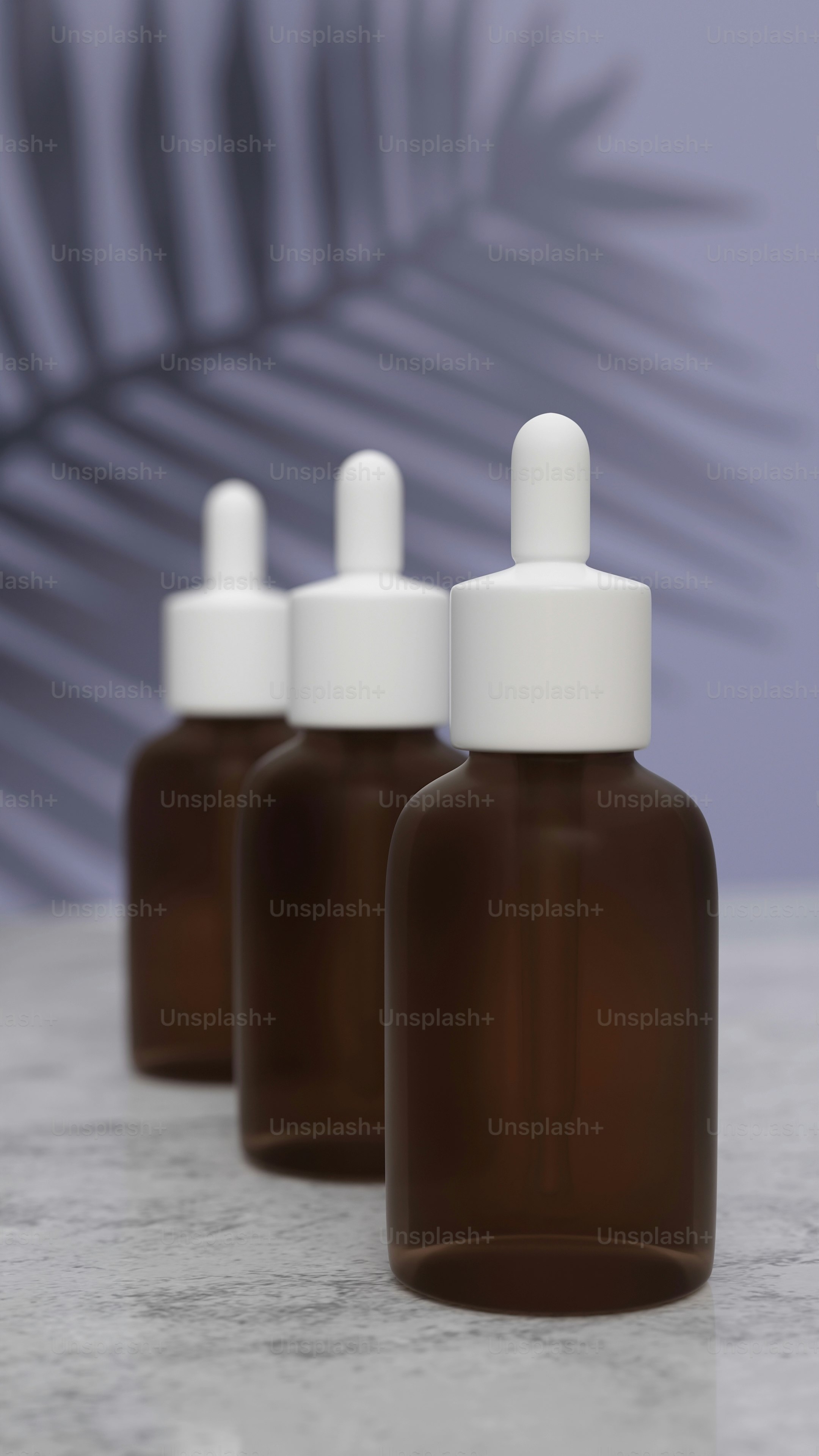 A group of three pink bottles sitting next to each other photo – Beauty ...