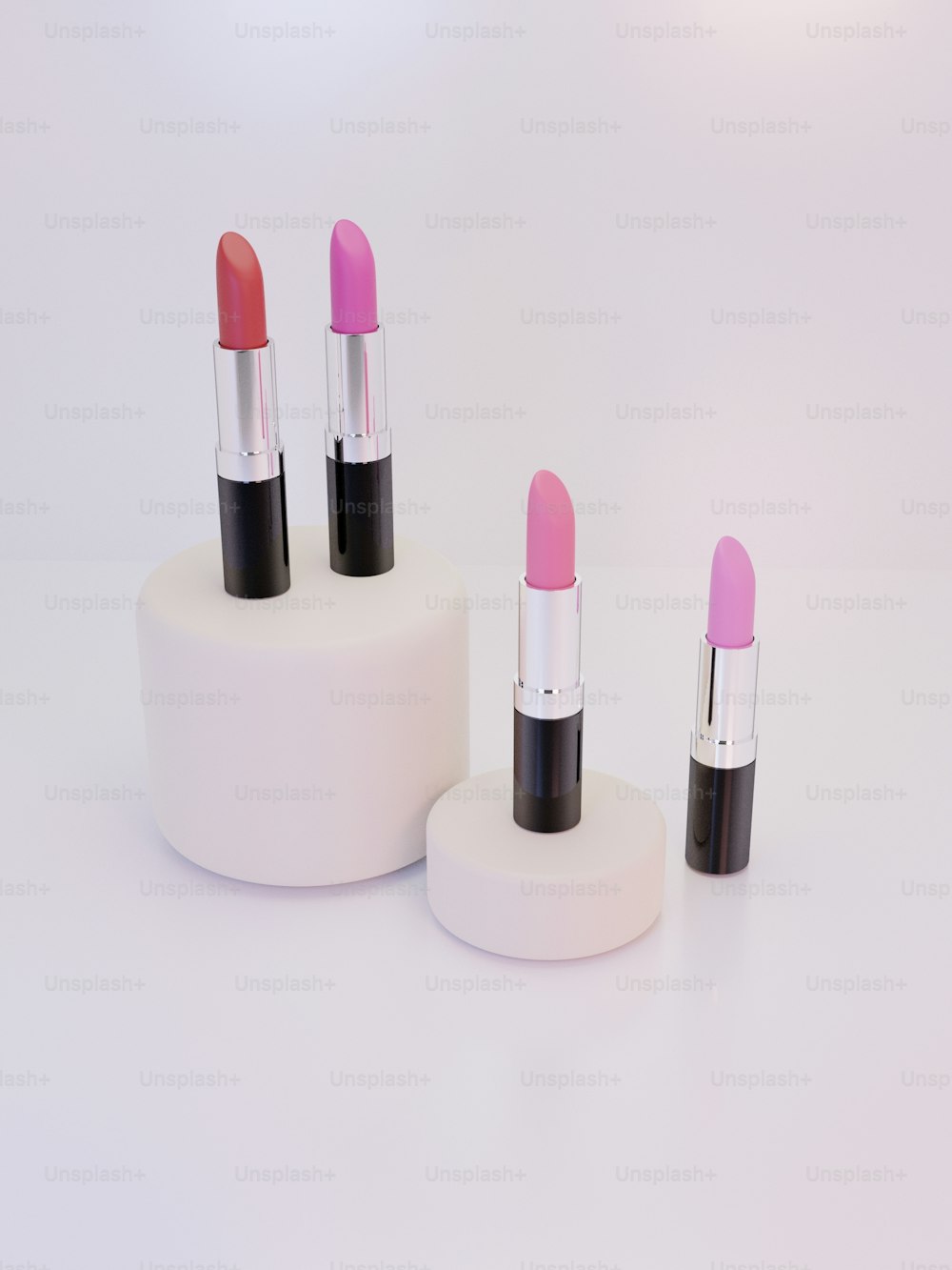 a group of three lipsticks sitting on top of a white stand