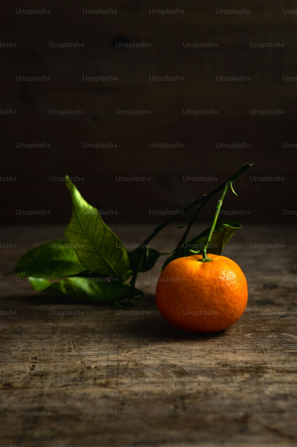 an orange sitting on top of a wooden table