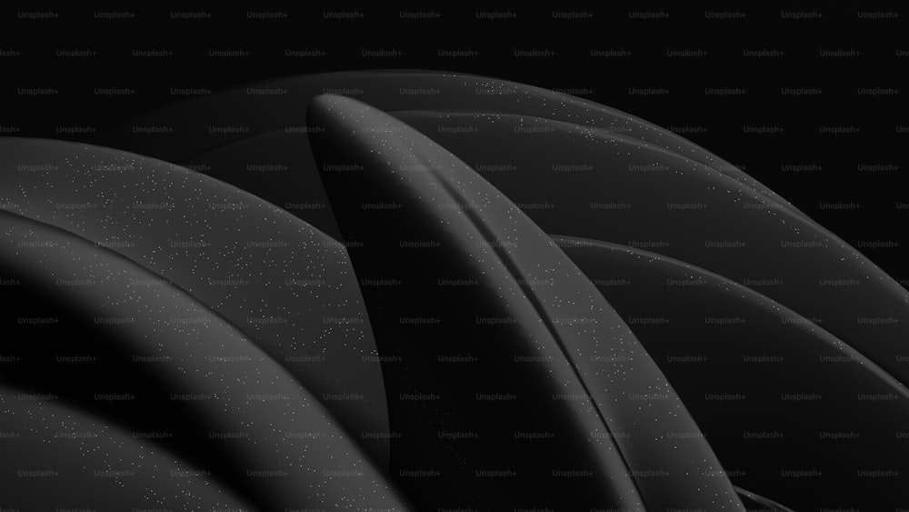 a close up of a black object with a black background