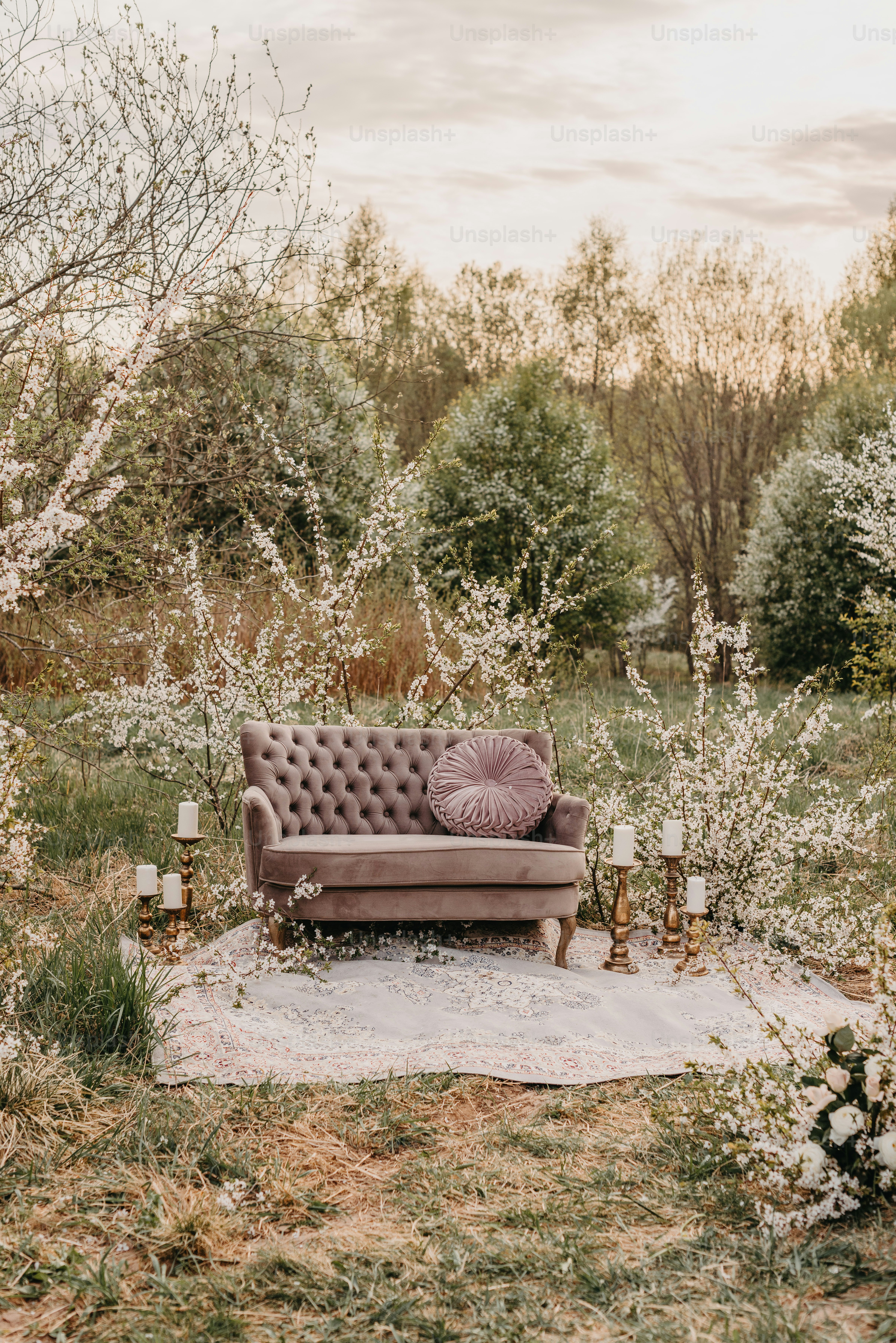 a couch sitting on top of a lush green field