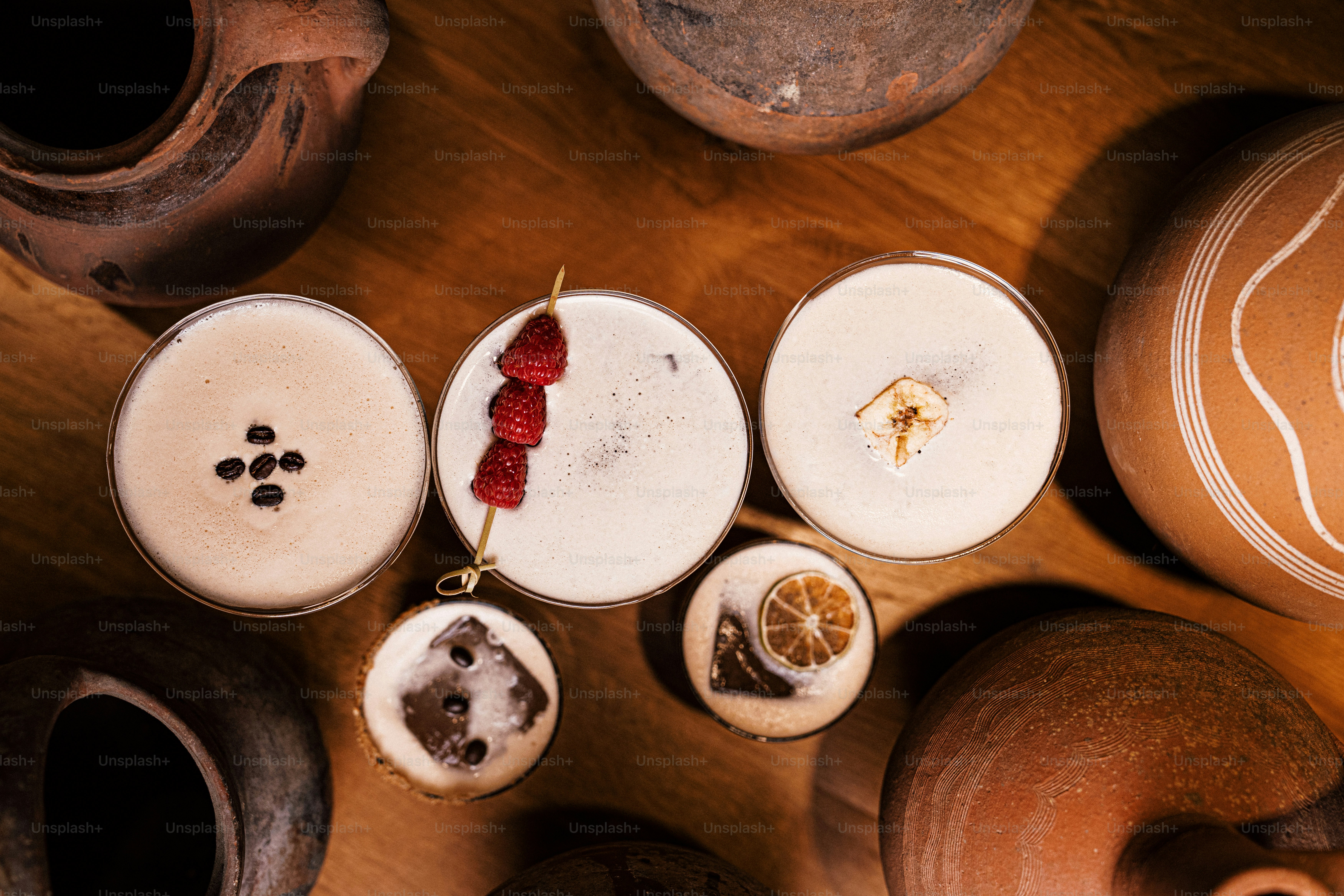 a table topped with pots and vases filled with fruit